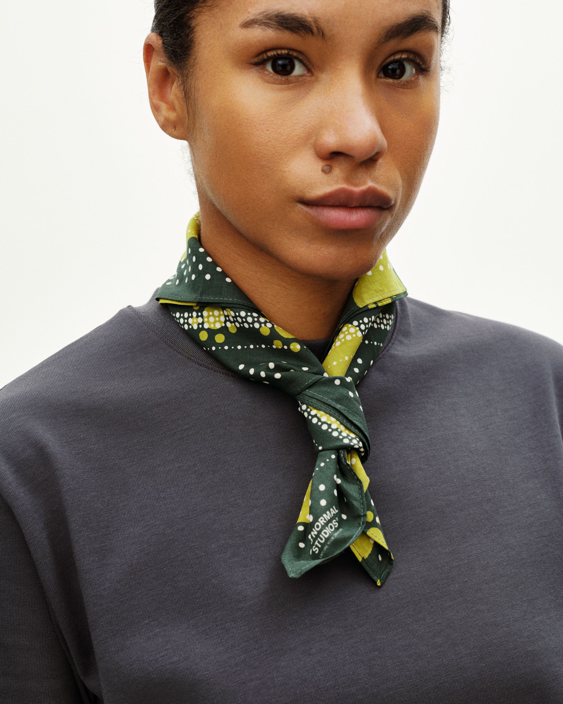Green Off-Race bandana on model with yellow and white polka dot pattern