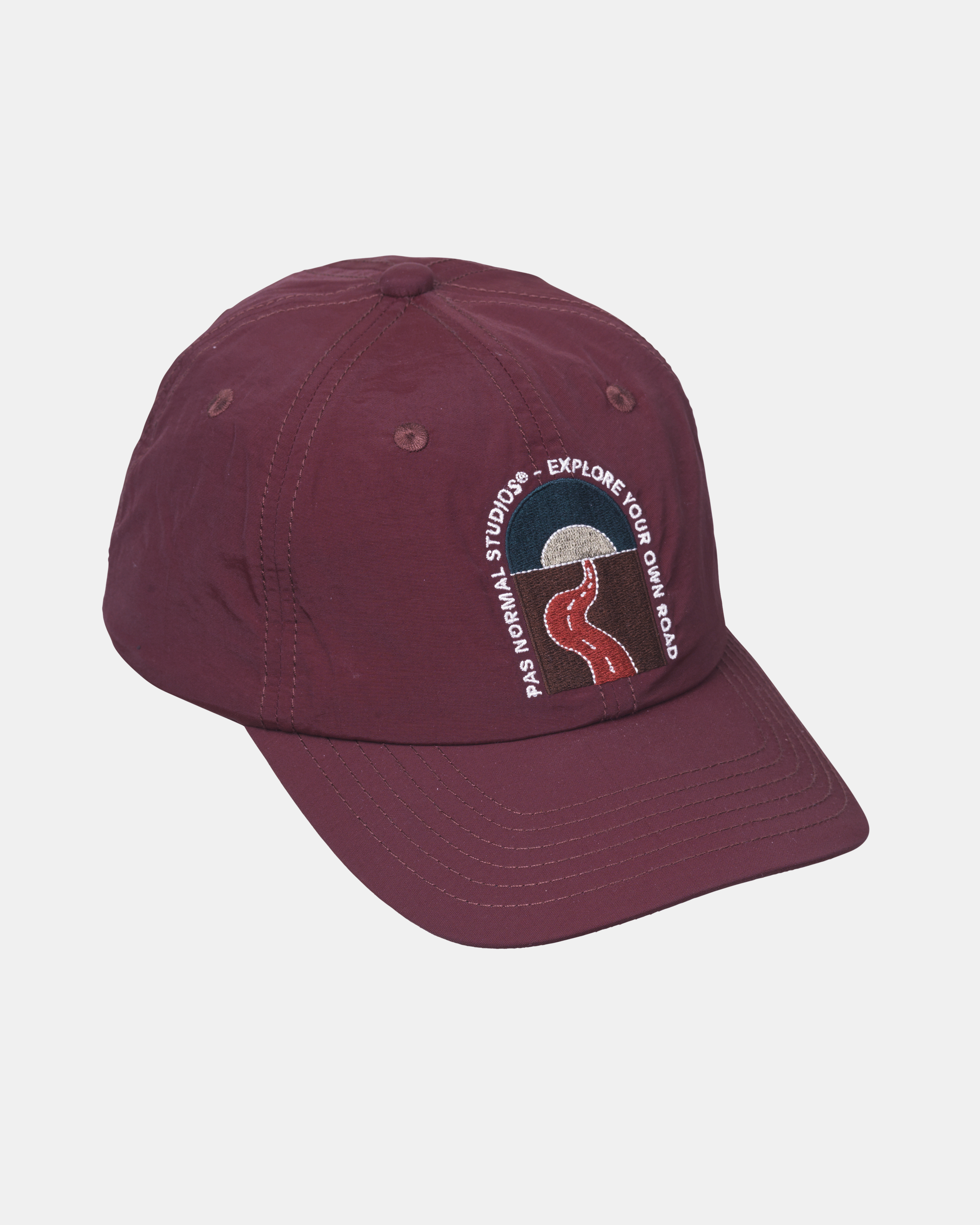 Maroon Off-Race cap, three-quarter view with circular embroidered logo on front panel