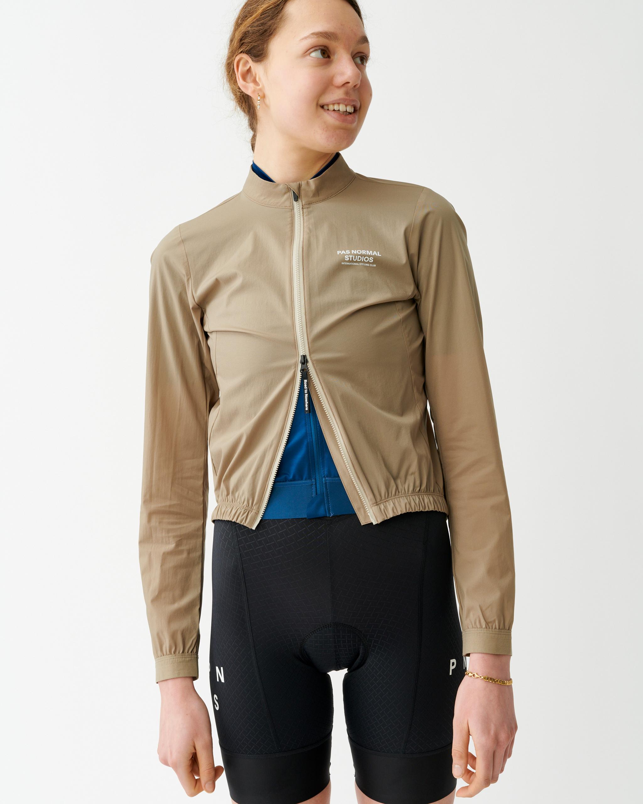 Beige Mechanism Stow Away jacket on model, front view with blue inner lining visible