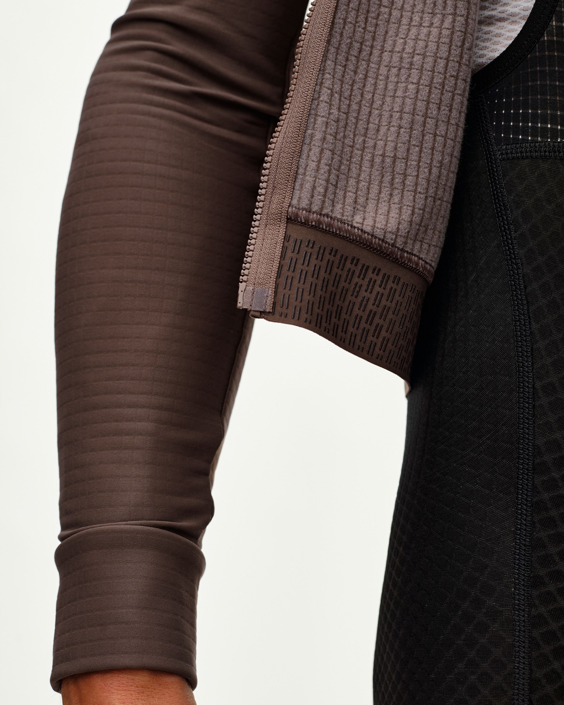 Dusty Plum Essential long sleeve cycling jersey, side detail on model with ribbed cuff and striped sleeve texture