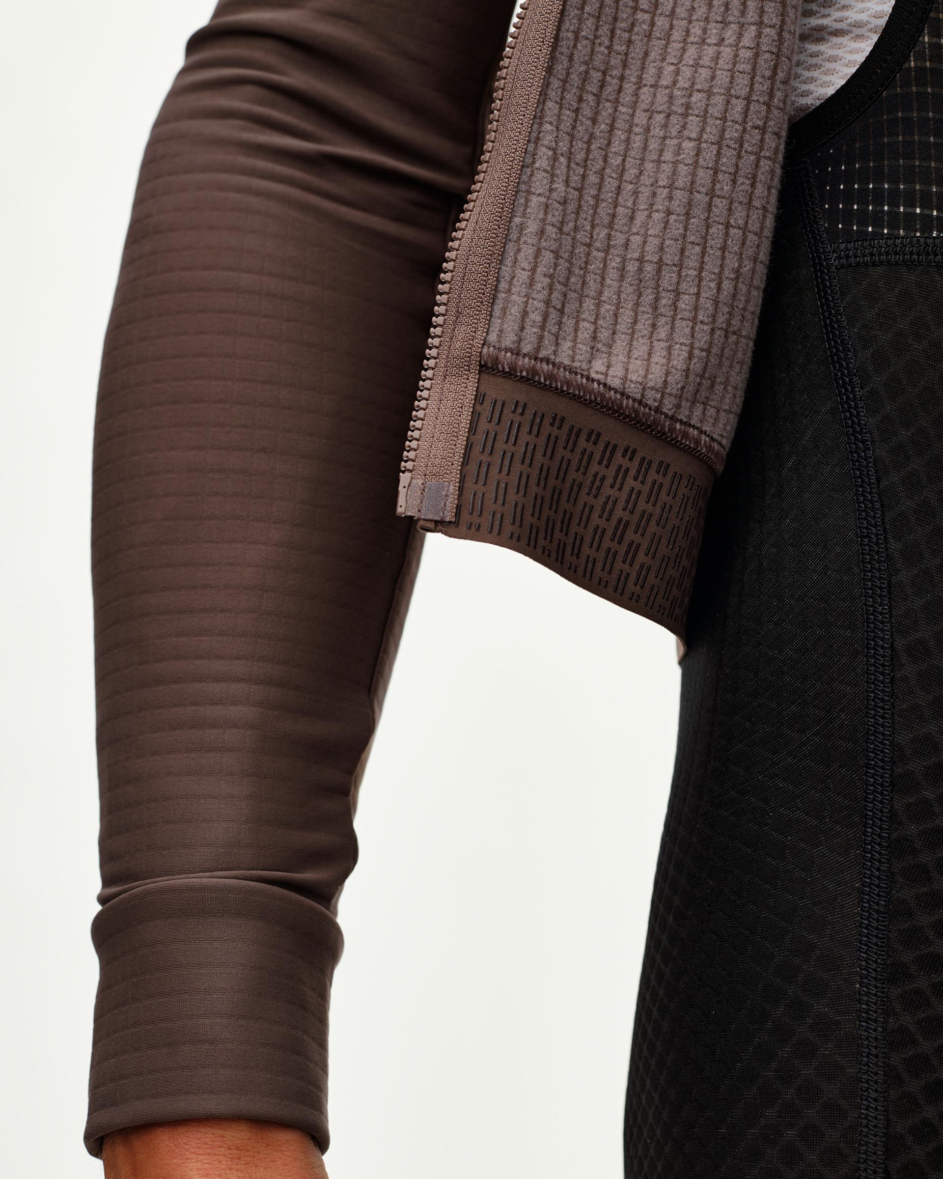 Dusty Plum Essential long sleeve cycling jersey, side detail on model with ribbed cuff and striped sleeve texture