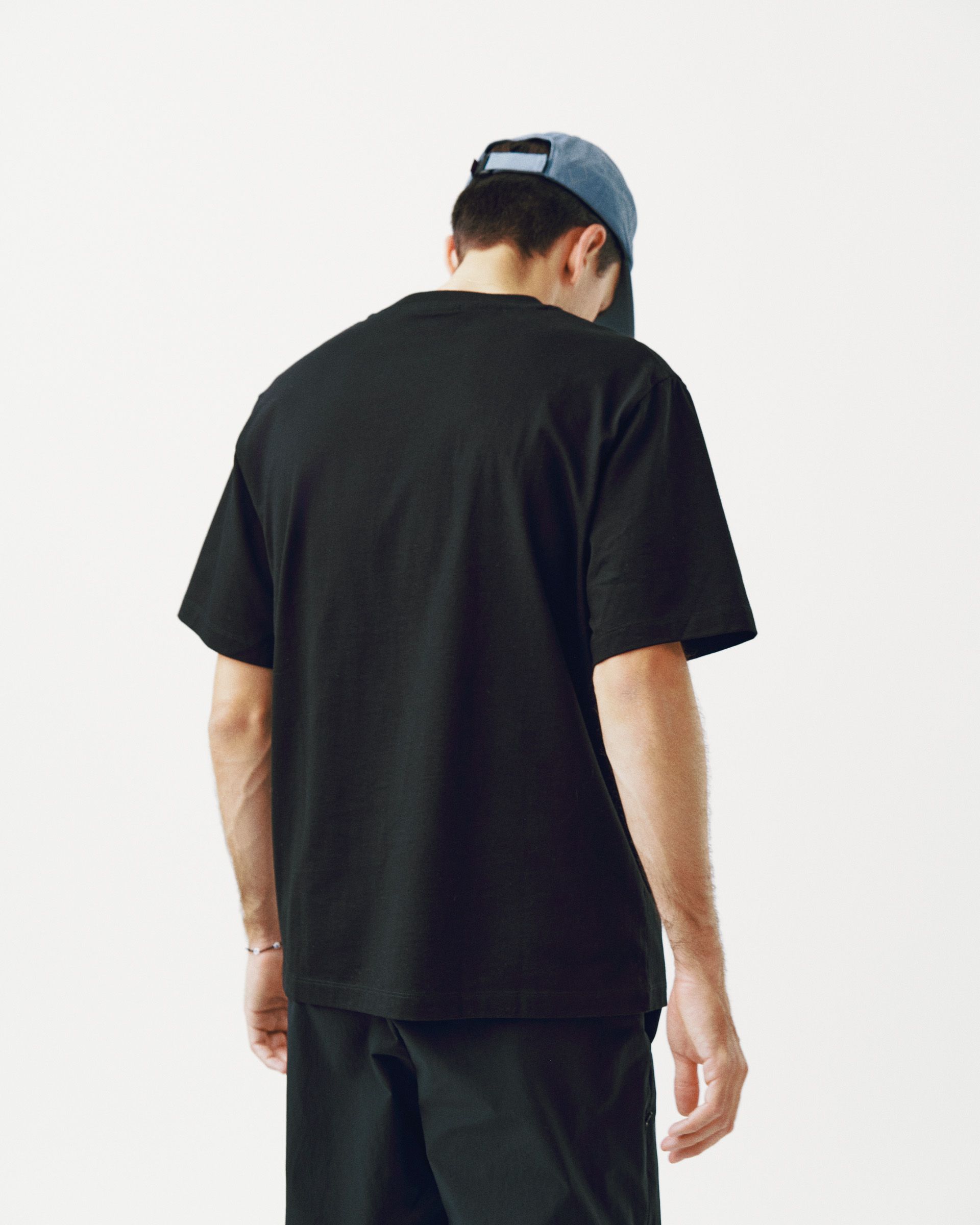 Black Off-Race Logo T-shirt on model, rear view with relaxed fit