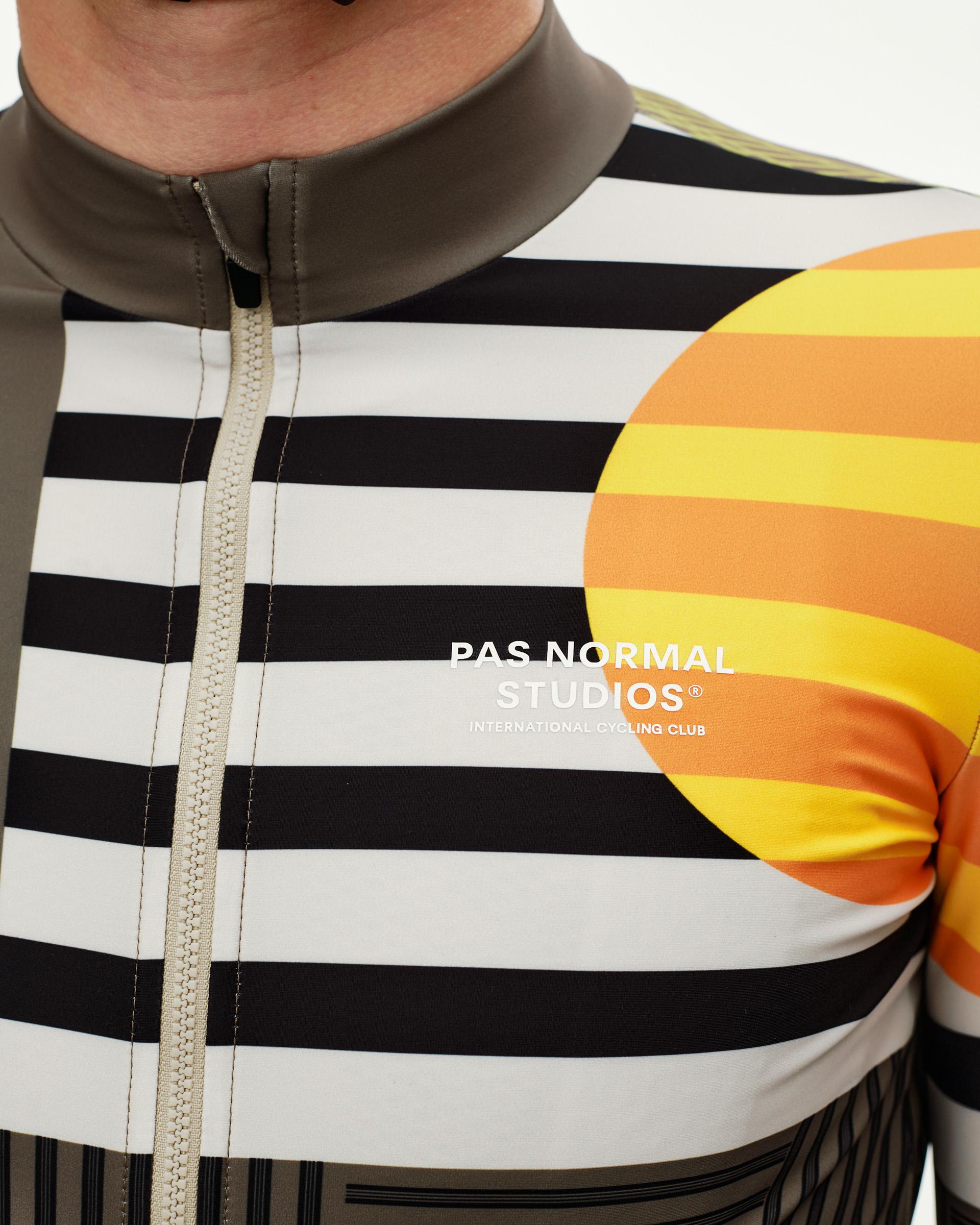 International Sand Mechanism long sleeve cycling jersey, front detail on model with black stripe and orange circle graphic