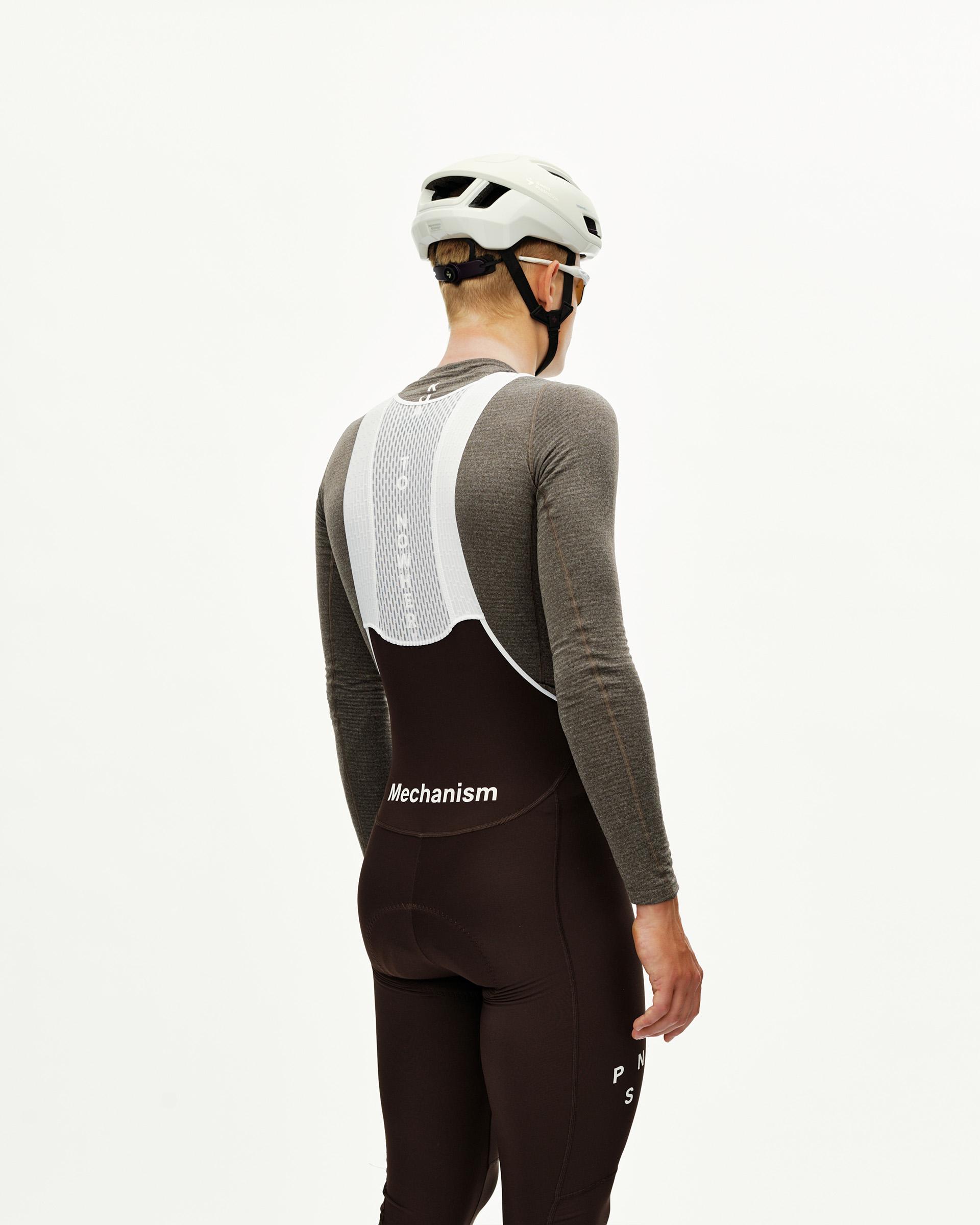 Dark Coffee Mechanism Thermal Long cycling bibs on model, rear view with white mesh bib strap