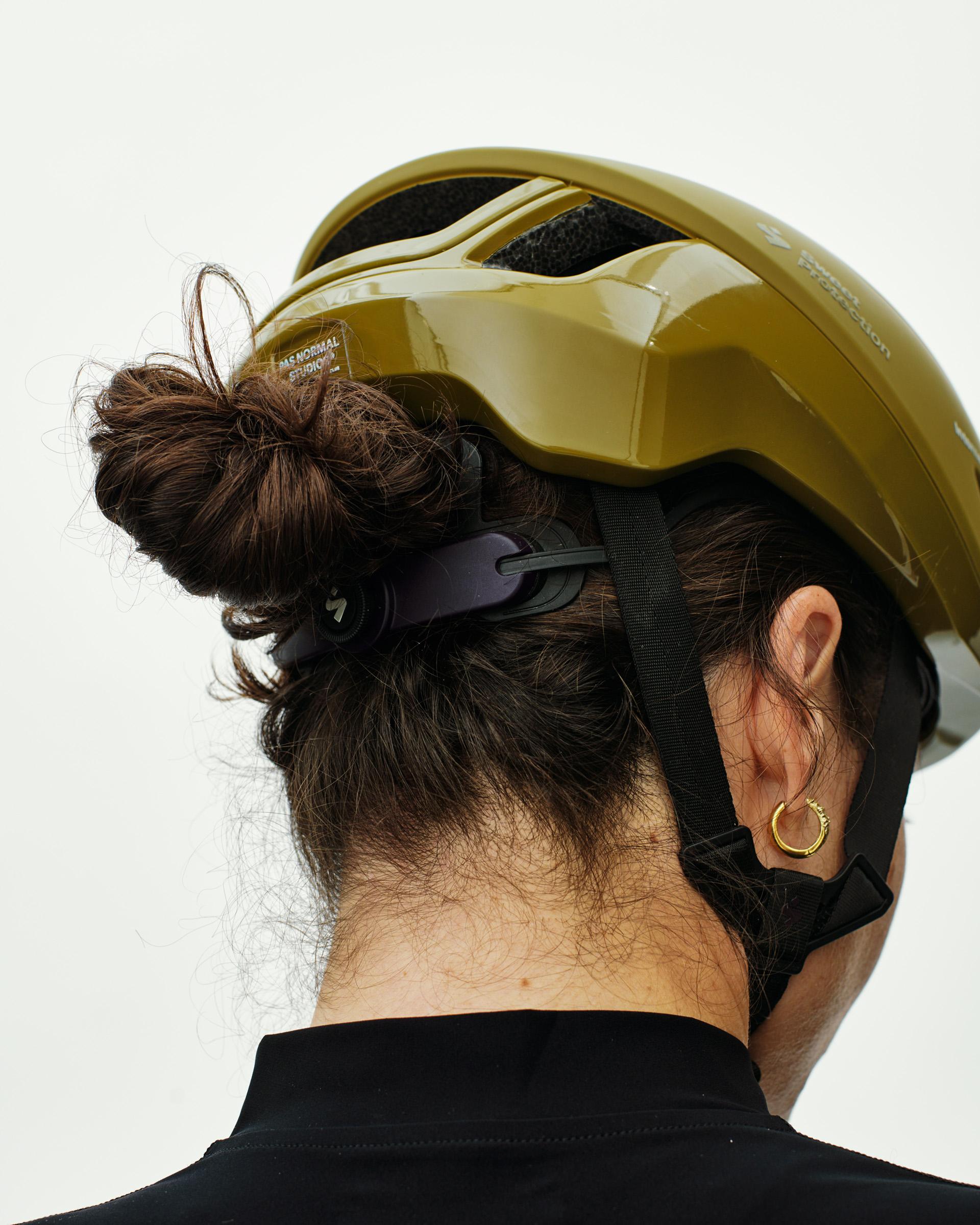 Khaki Green Sweet Protection Falconer Aero2Vi cycling helmet, rear three-quarter view on model