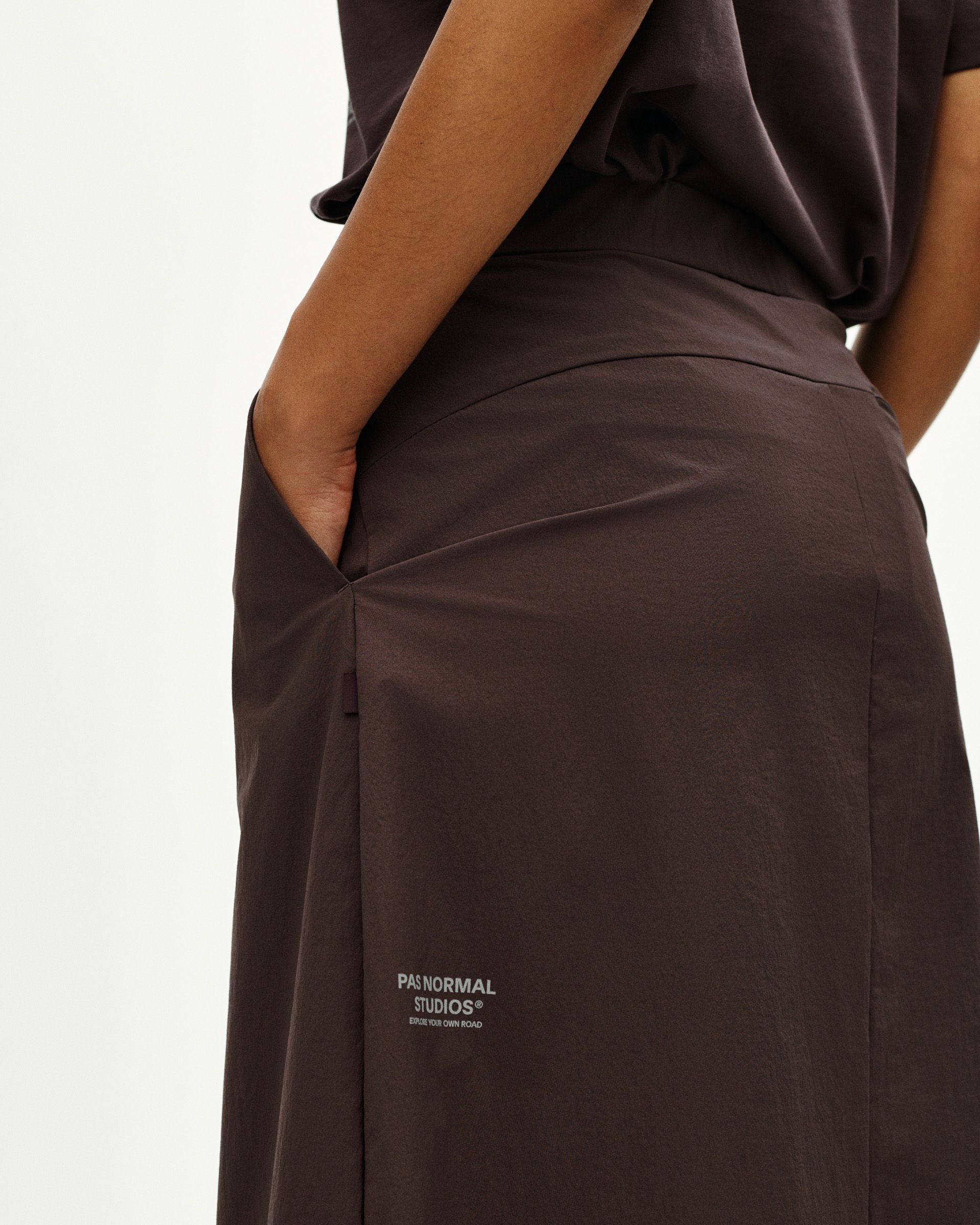 Dark Purple Off-Race Tech Skirt on model, side view with elastic waistband