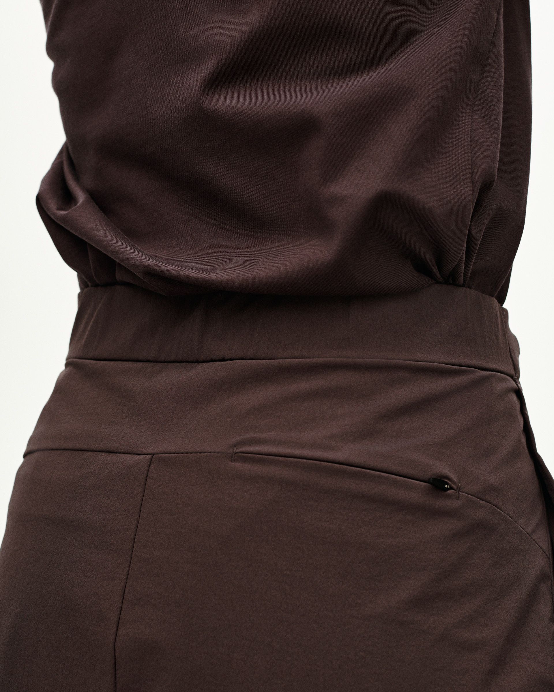 Purple Off-Race Tech skirt, side view on model with zip pocket detail