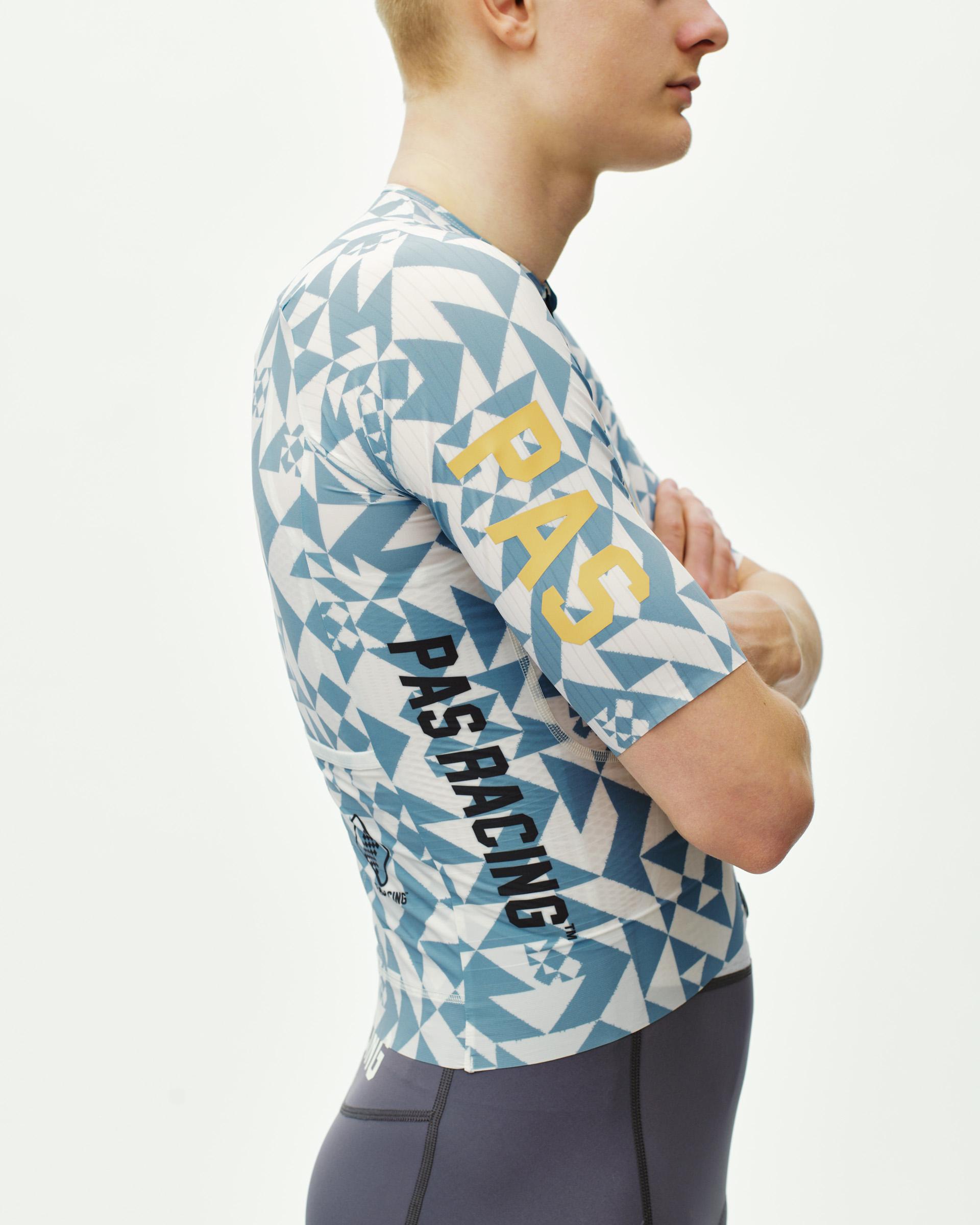 Origami Light Blue PAS Mechanism Pro cycling jersey on model, side view with geometric print and yellow sleeve logo
