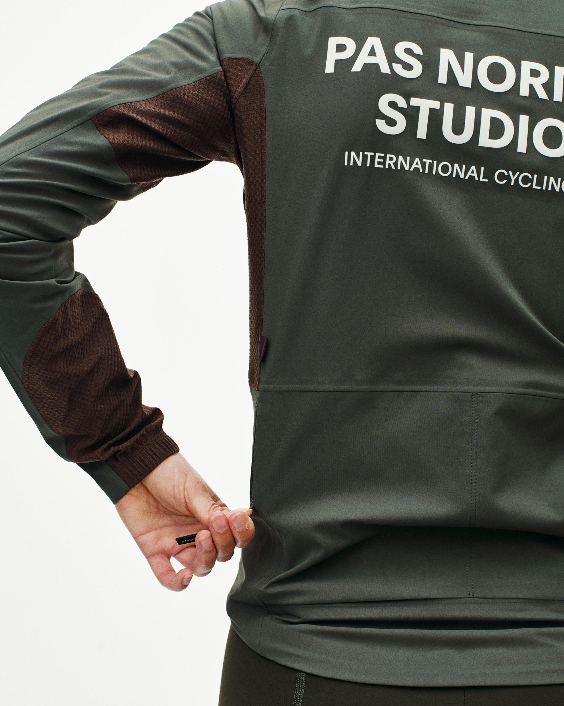 Dark Grey Mechanism Shell cycling jacket on model with brown contrast sleeves