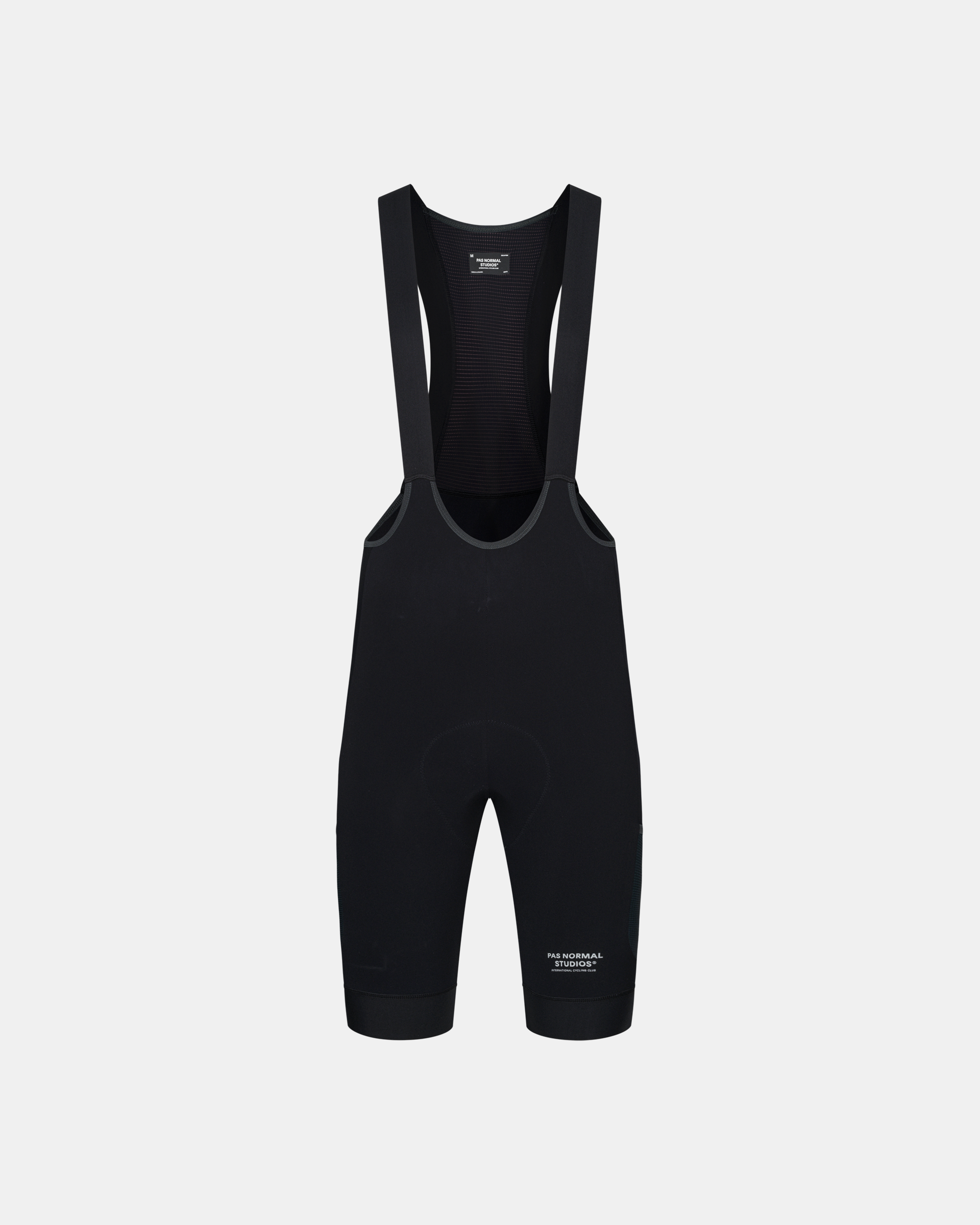 Black Escapism Cargo cycling bibs, front flat lay with mesh bib panel and cargo pockets