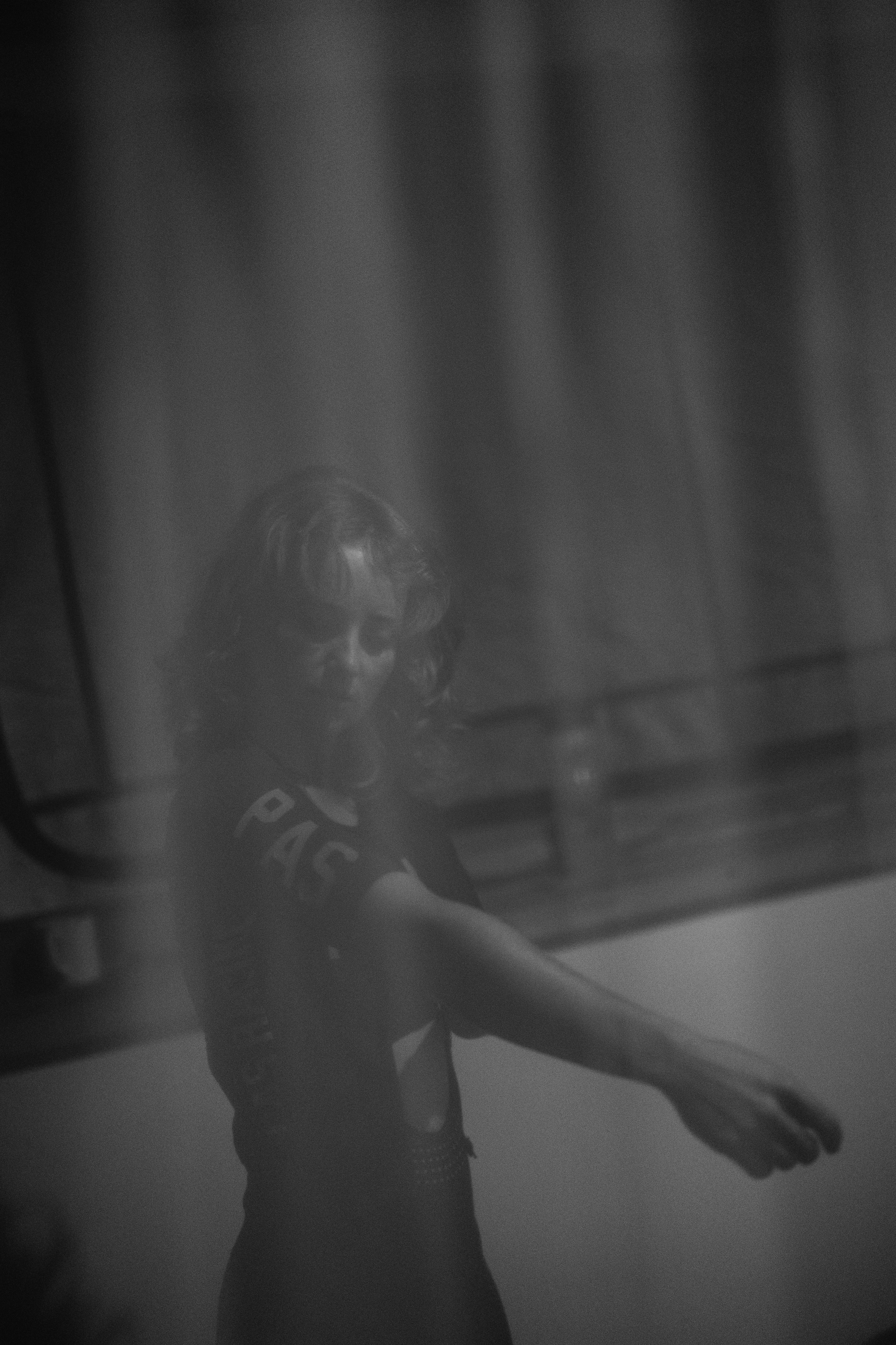 Model wearing cycling apparel in black and white atmospheric shot
