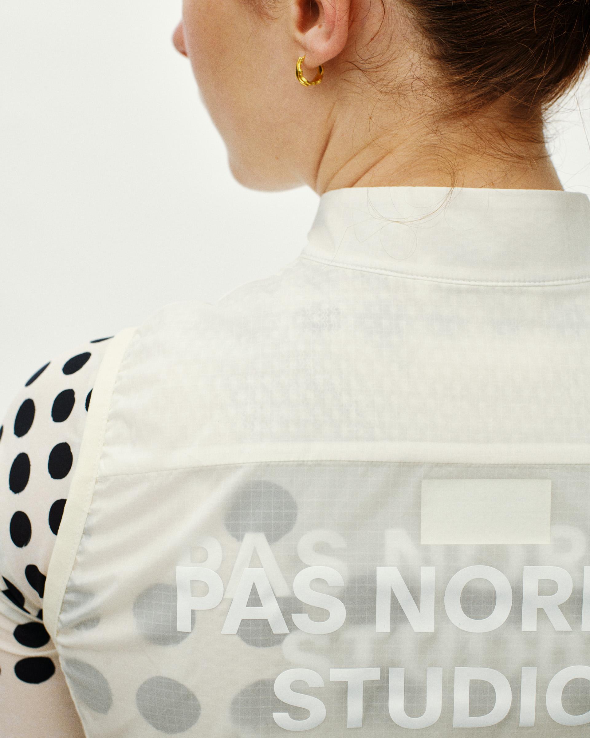 Off White Essential cycling gilet on model, rear detail view with polka dot sleeve panel and branded back print