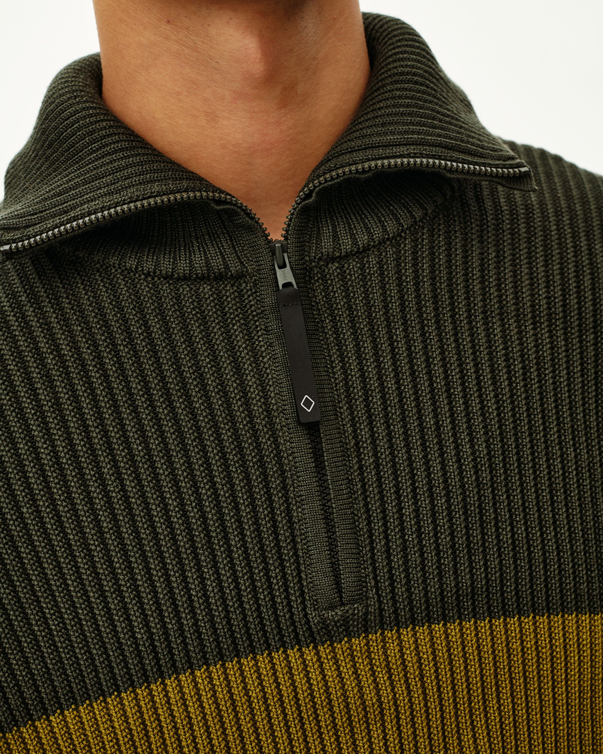 Olive Off-Race Merino Knit Half-Zip sweater, front detail on model with contrast mustard stripe and half-zip collar