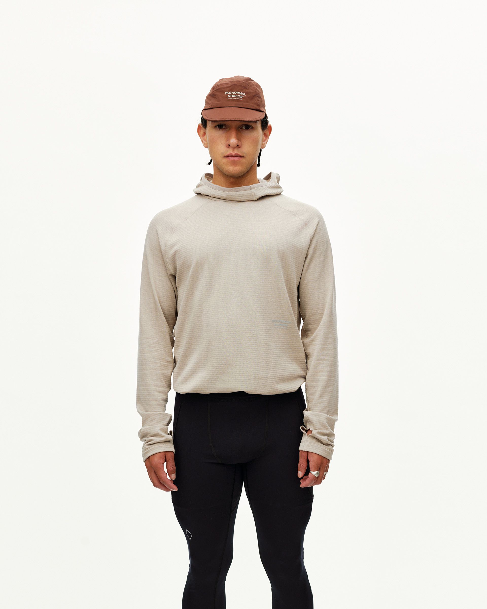 Black Balance Long Tights on model, front view worn with beige hooded top