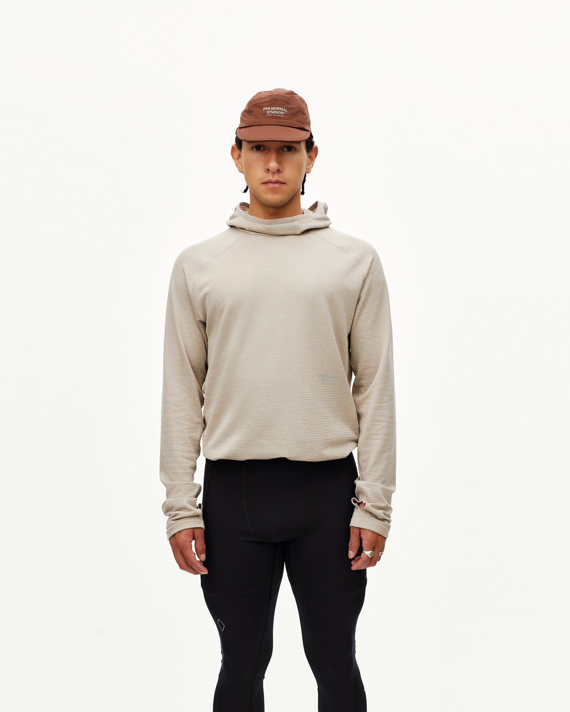 Black Balance Long Tights on model, front view worn with beige hooded top