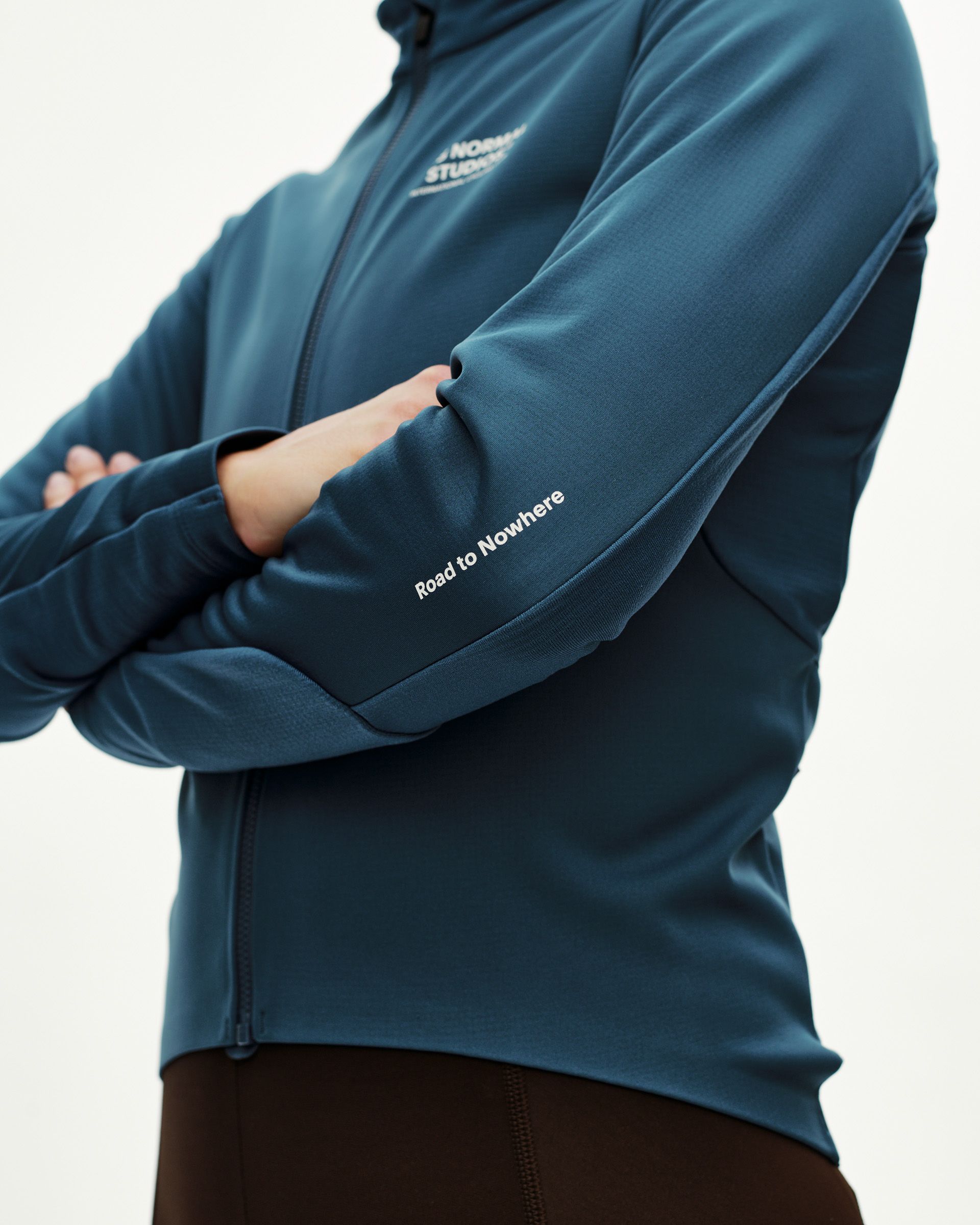 Denim Blue Mechanism Thermal Long Sleeve cycling jersey on model, front detail with Road to Nowhere sleeve print