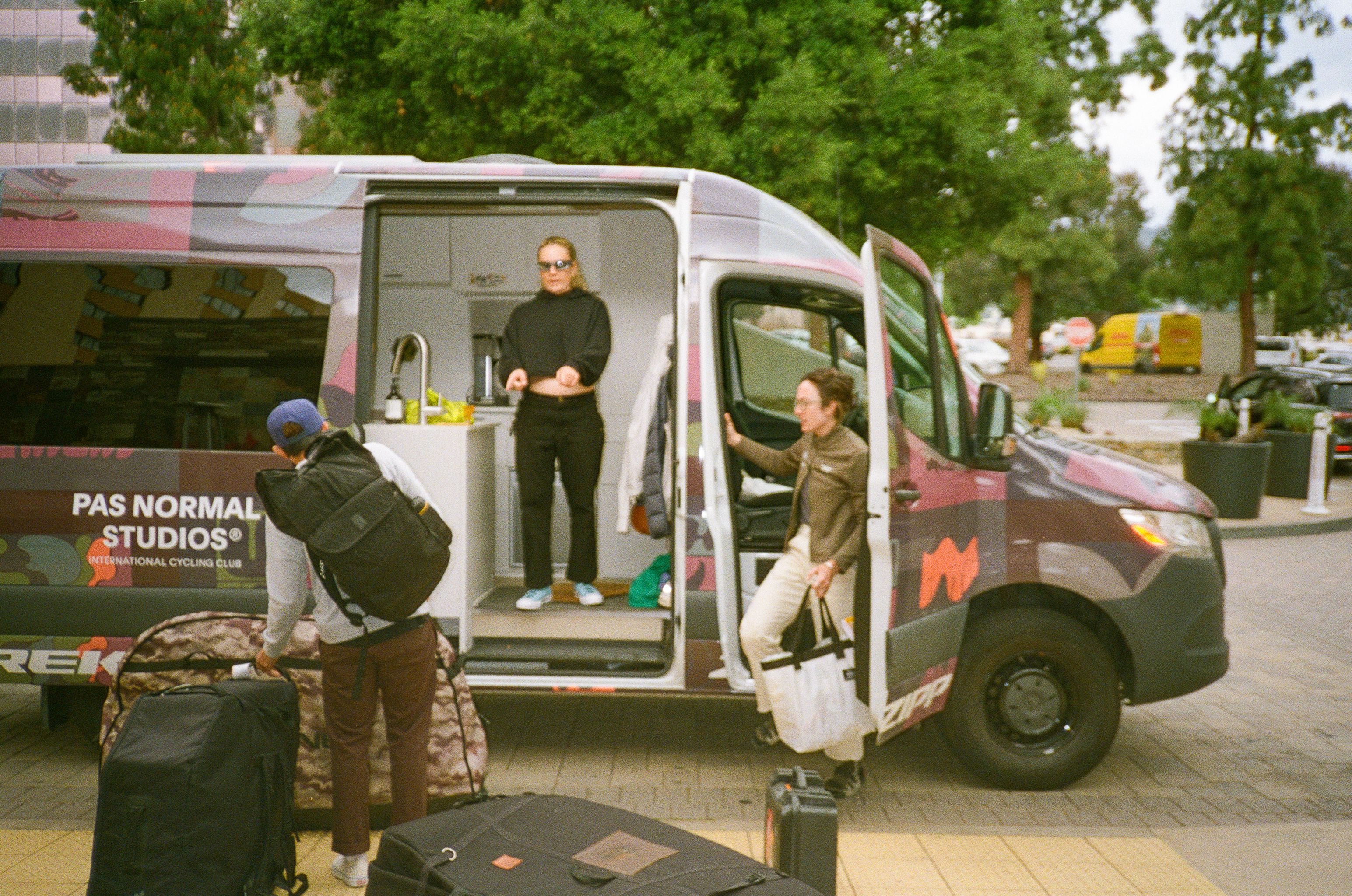 Cyclists at branded camper van preparing for ride in Death Valley
