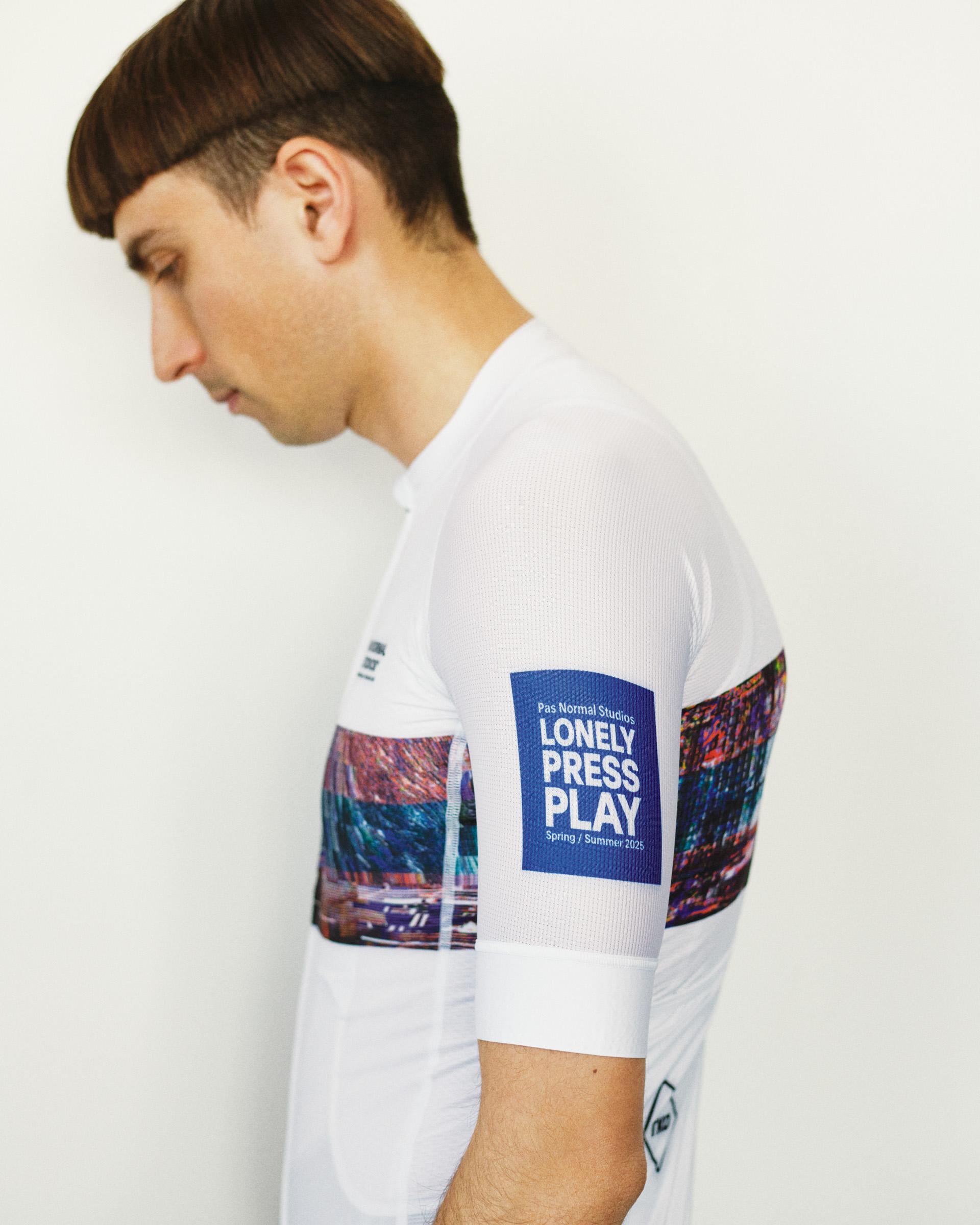 White T.K.O. Mechanism cycling jersey on model, side view with photographic sleeve print and blue branded panel
