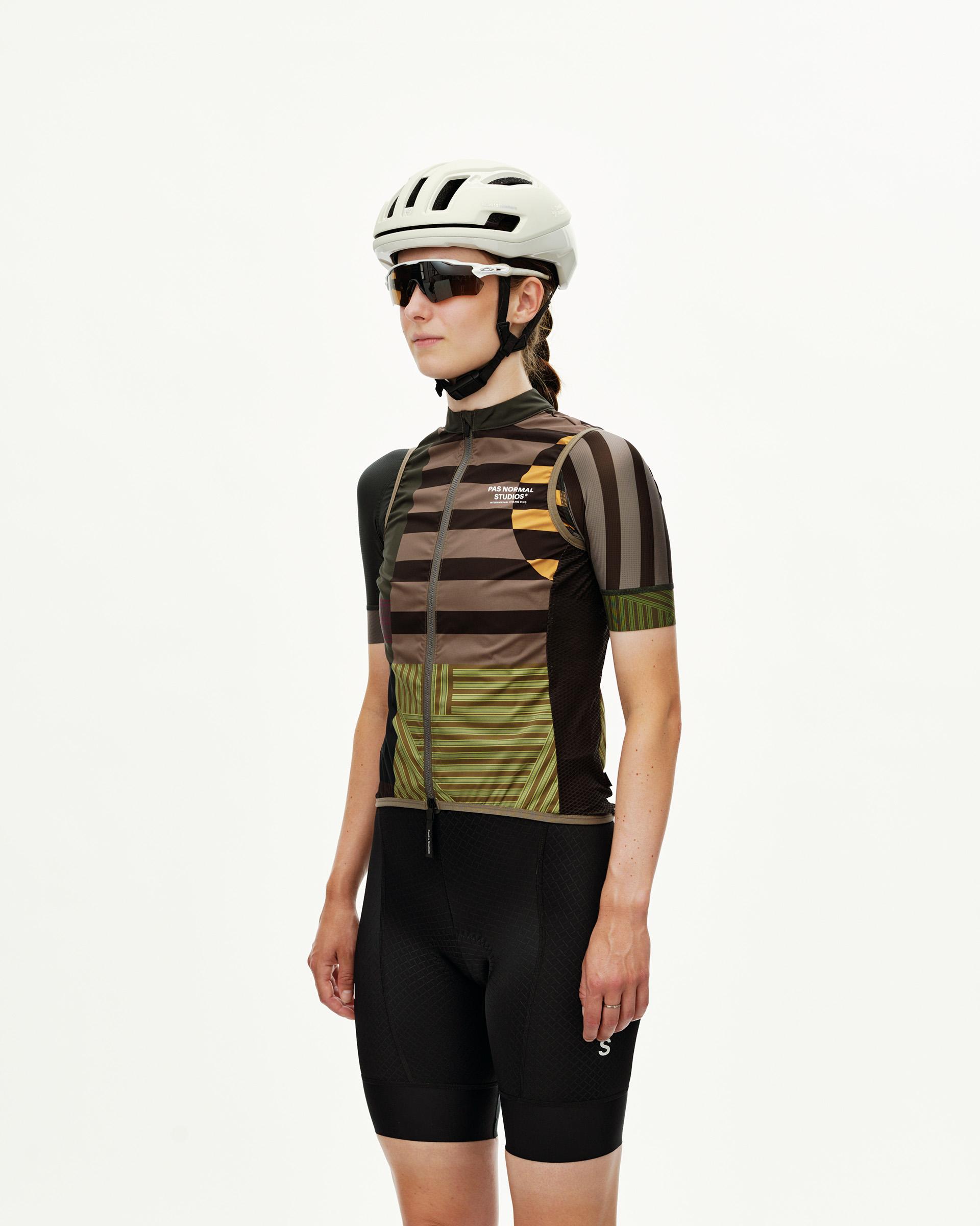 Terrain Earth brown Mechanism Stow Away women's cycling gilet on model, front view with multicolour stripe print