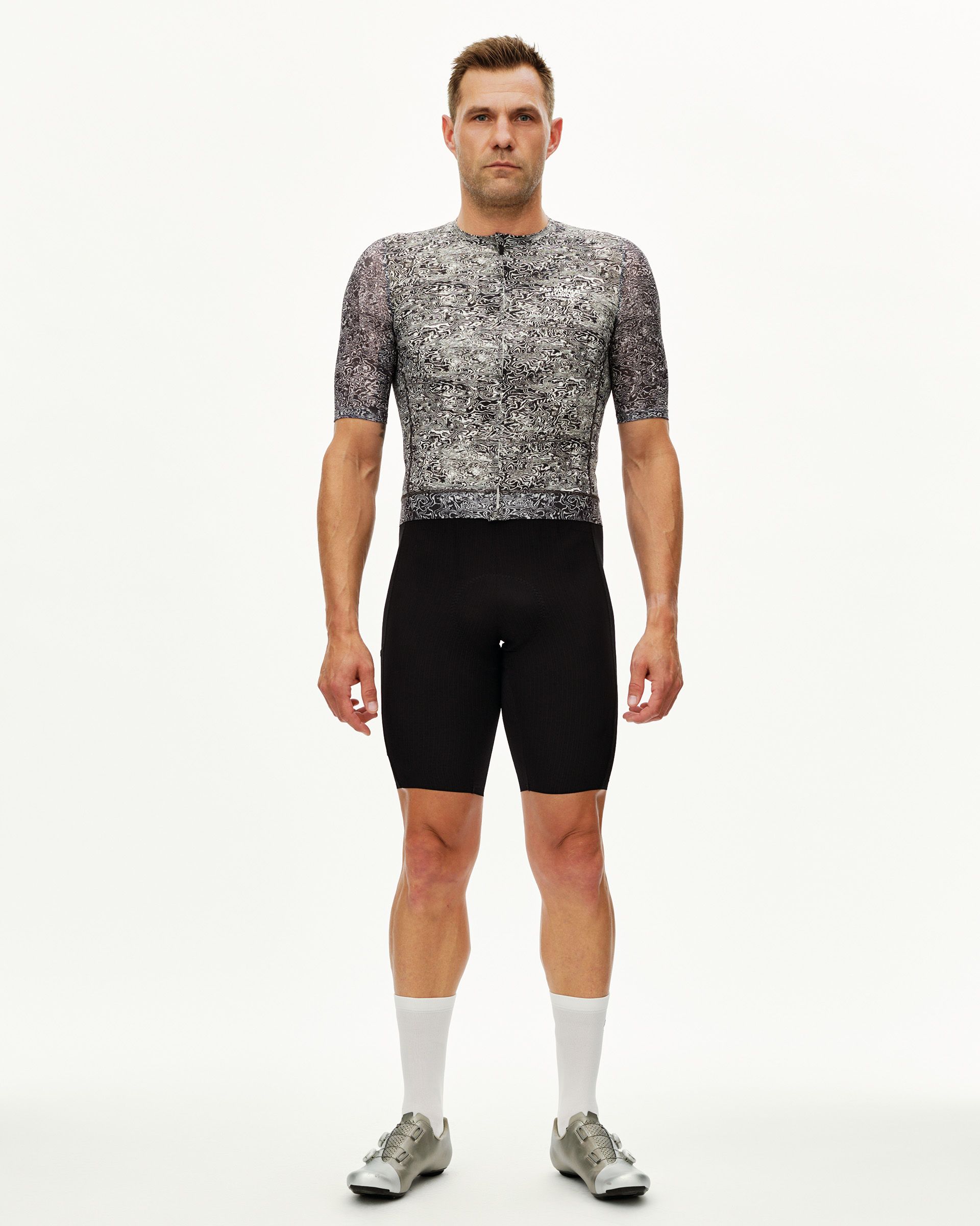 Off White Essential cycling jersey on male model, front view with all-over black and white abstract print