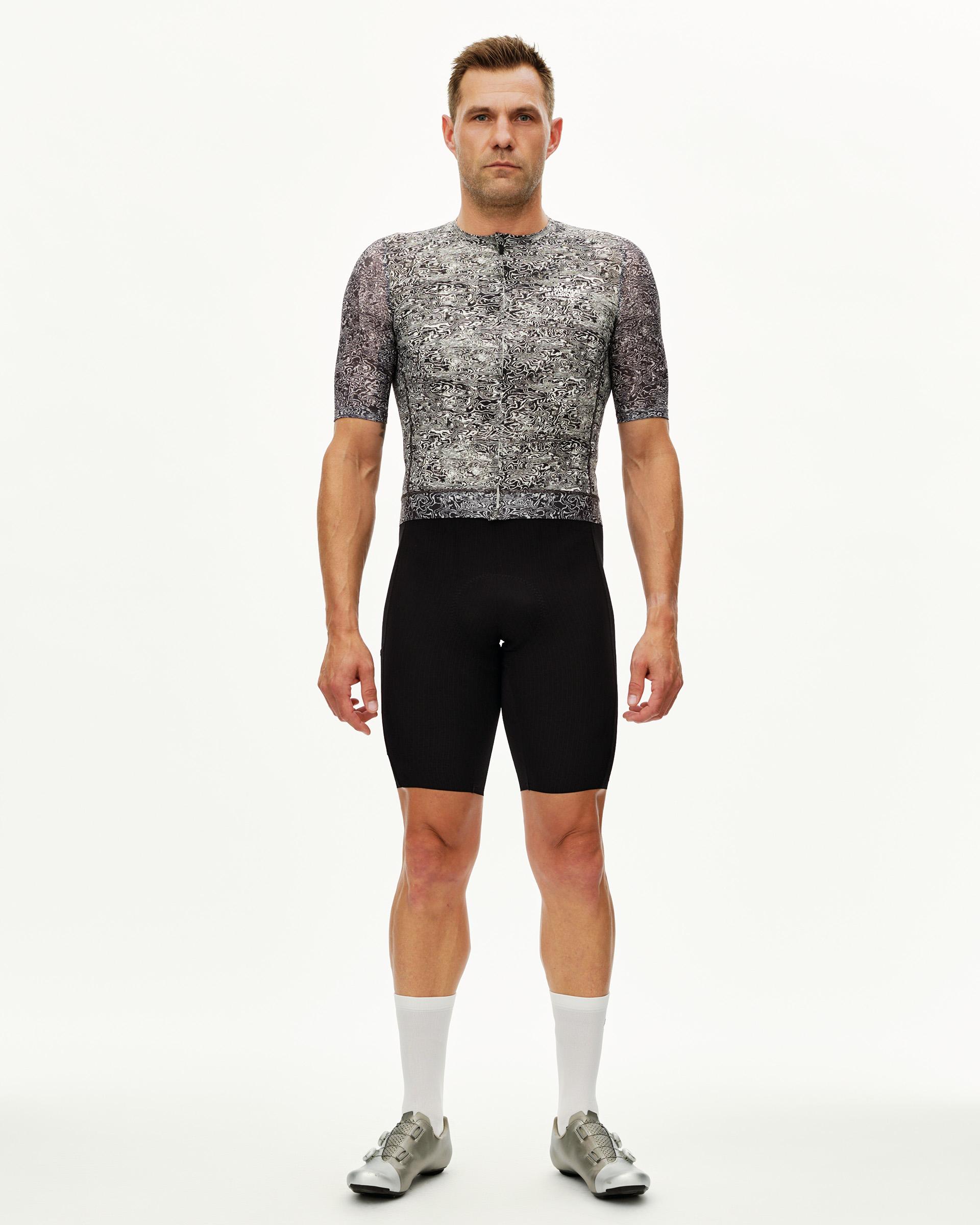 Off White Essential cycling jersey on male model, front view with all-over black and white abstract print