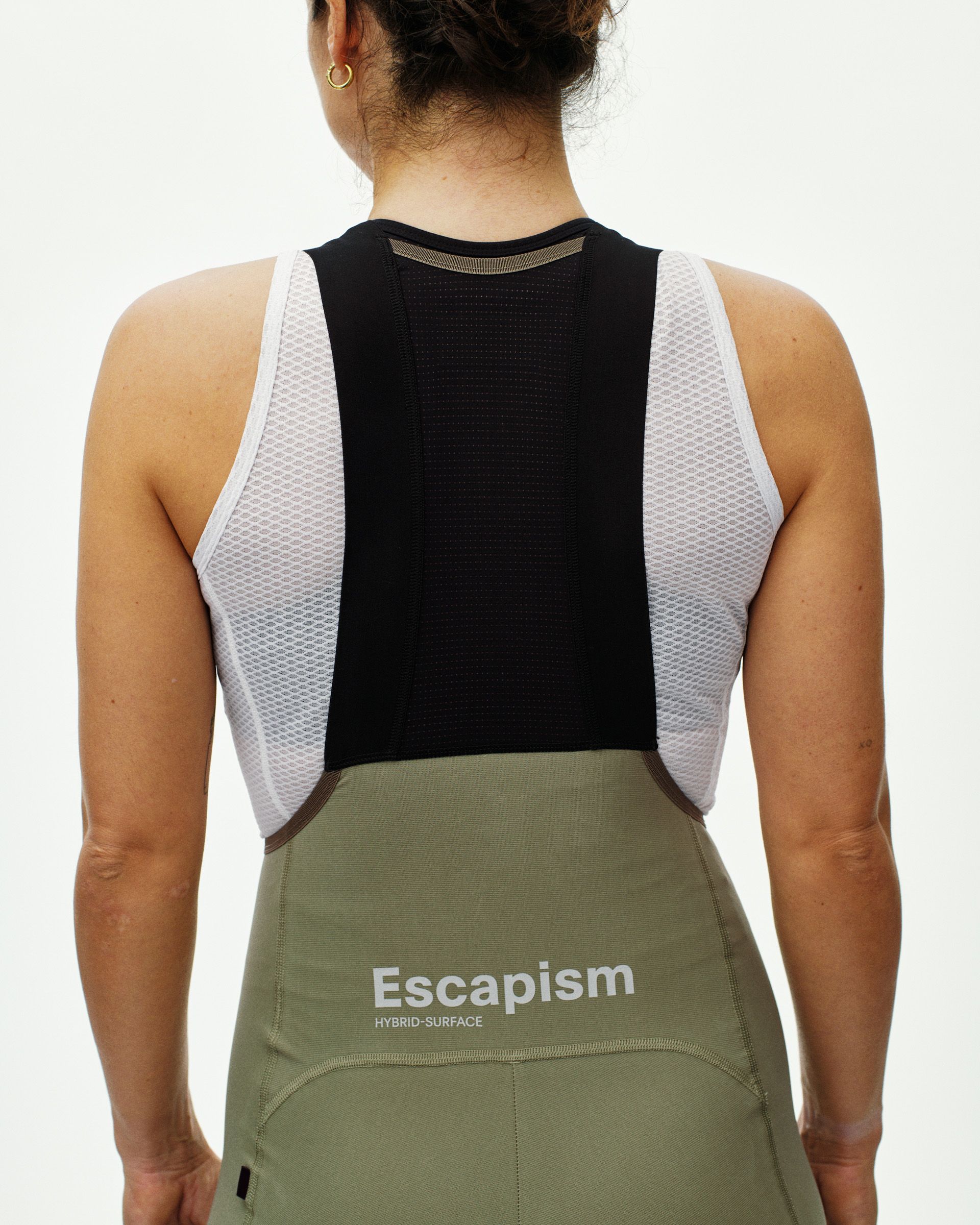 Light Olive Escapism cargo bibs on model, rear view with white mesh panels and Escapism logo