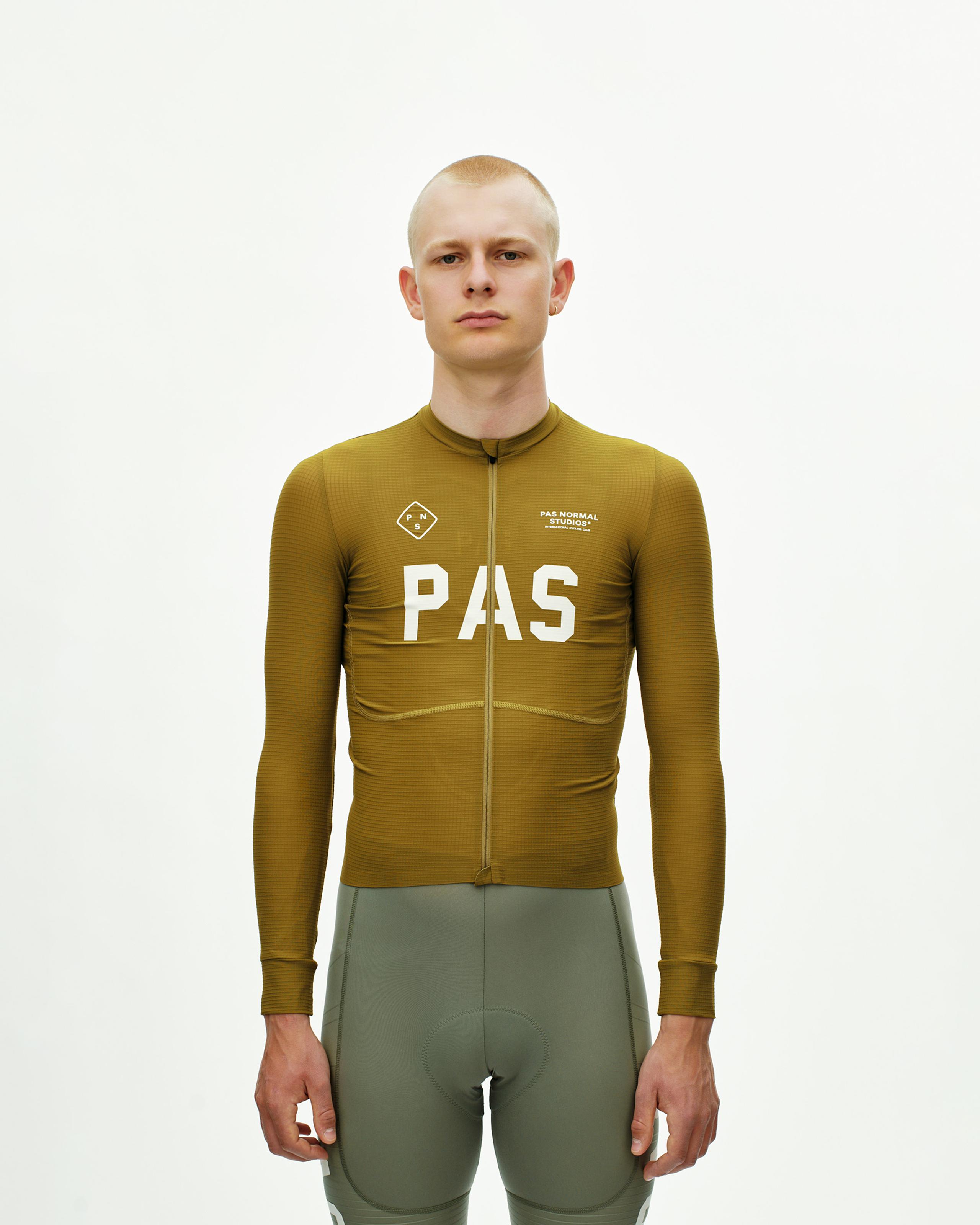 Khaki Green PAS Mechanism Pro long sleeve cycling jersey on model with white chest print