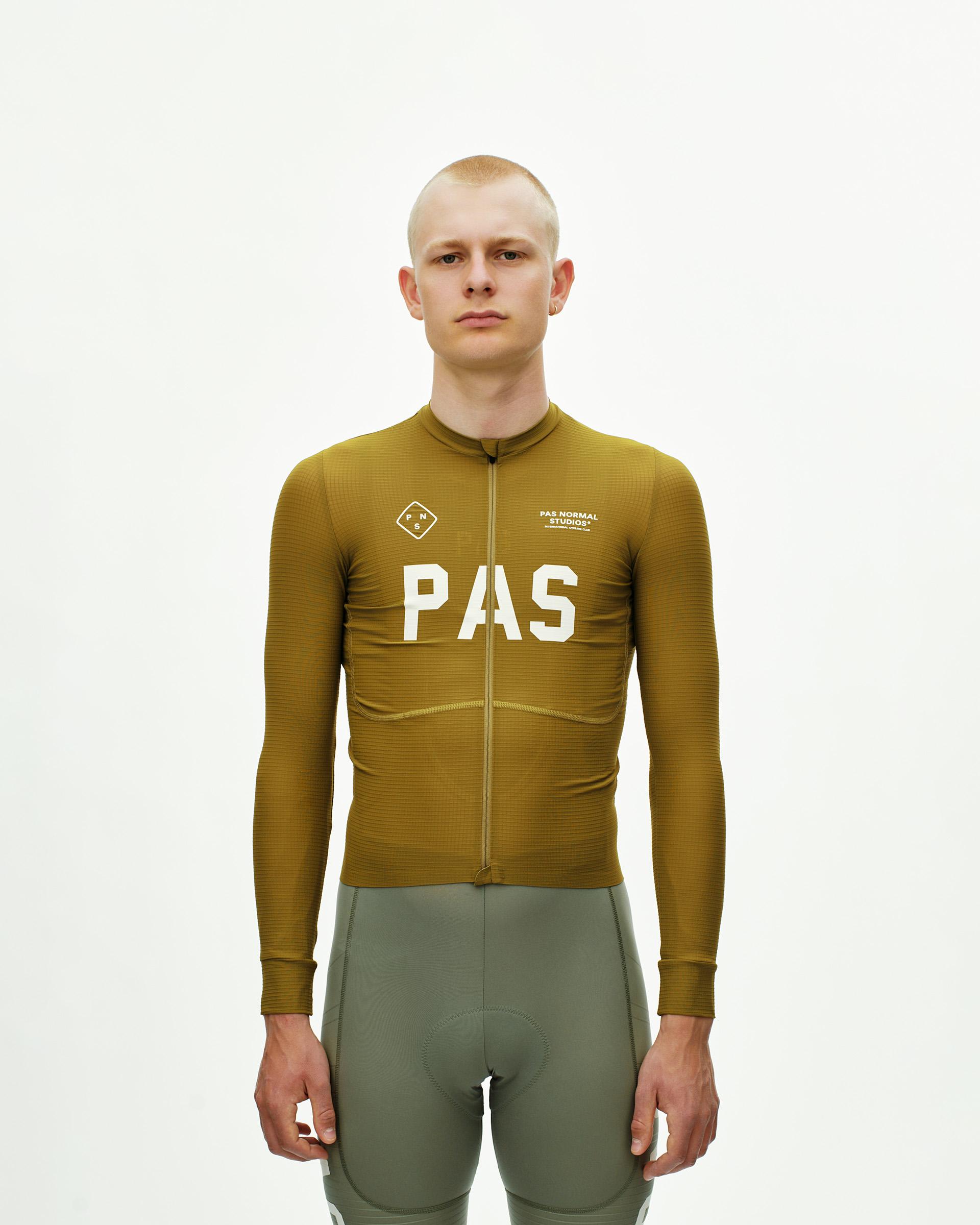 Khaki Green PAS Mechanism Pro long sleeve cycling jersey on model with white chest print