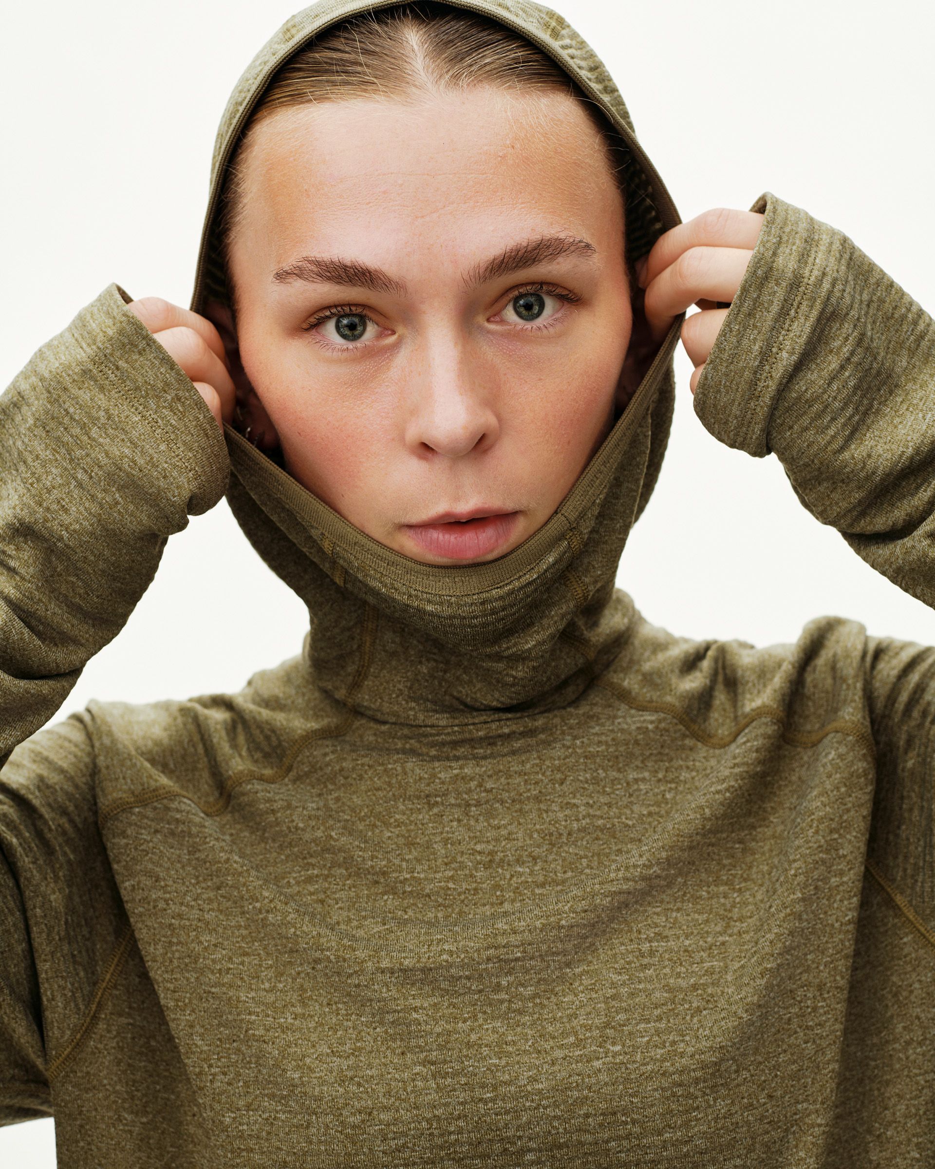 Moss Brown Balance Thermal Hoodie on model, front view with hood pulled up over face and high neck collar