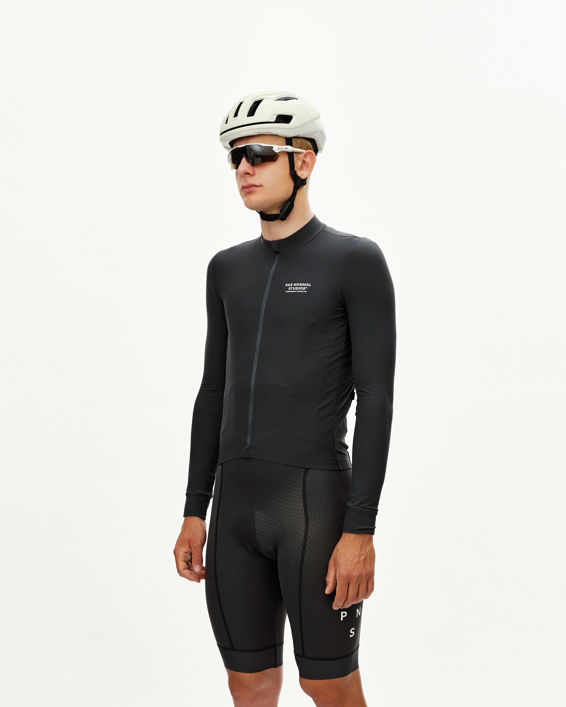 Dark Navy Mechanism long sleeve cycling jersey on model, front three-quarter view with chest text print