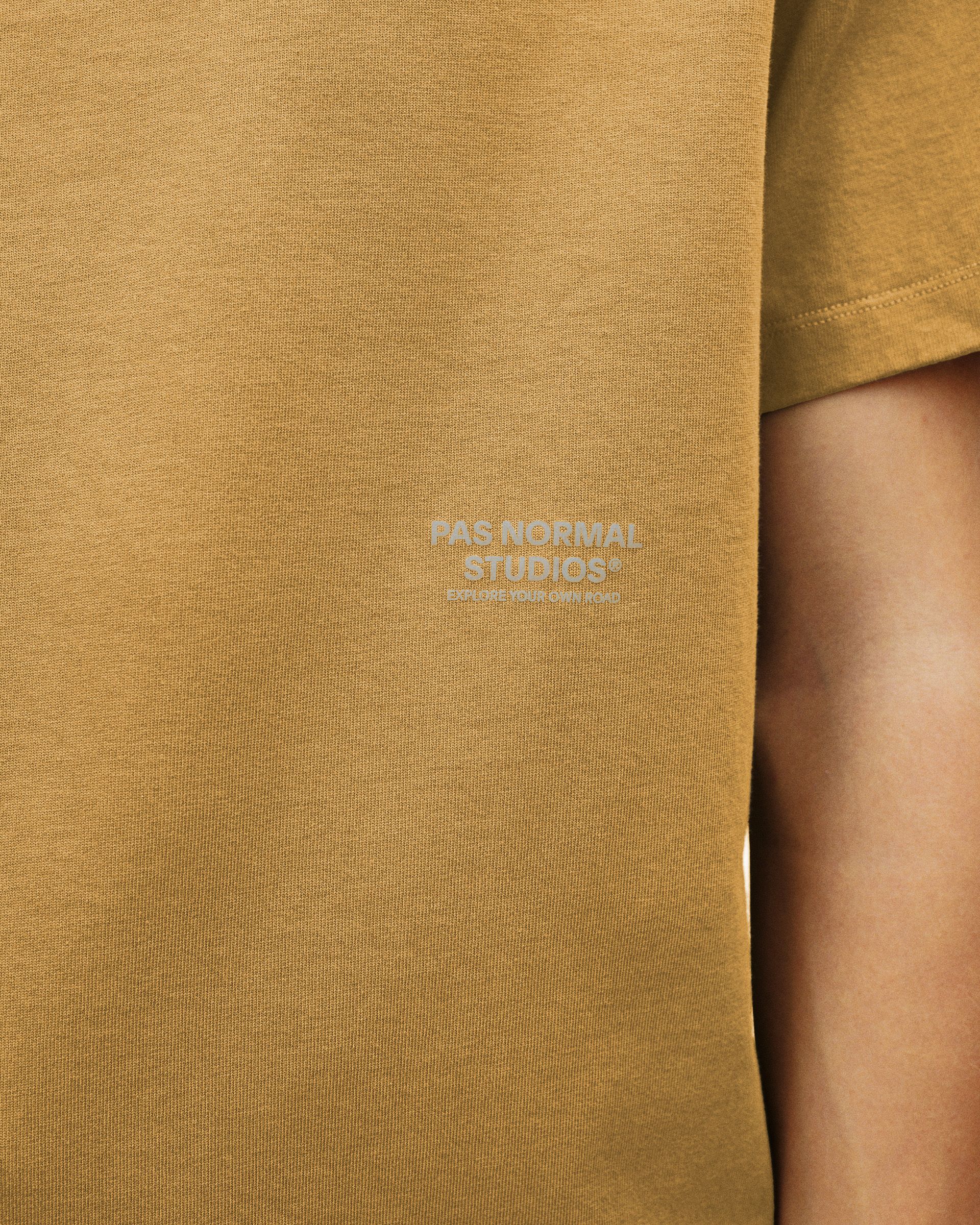 Brown Off-Race T-shirt, chest detail view on model with tonal logo print