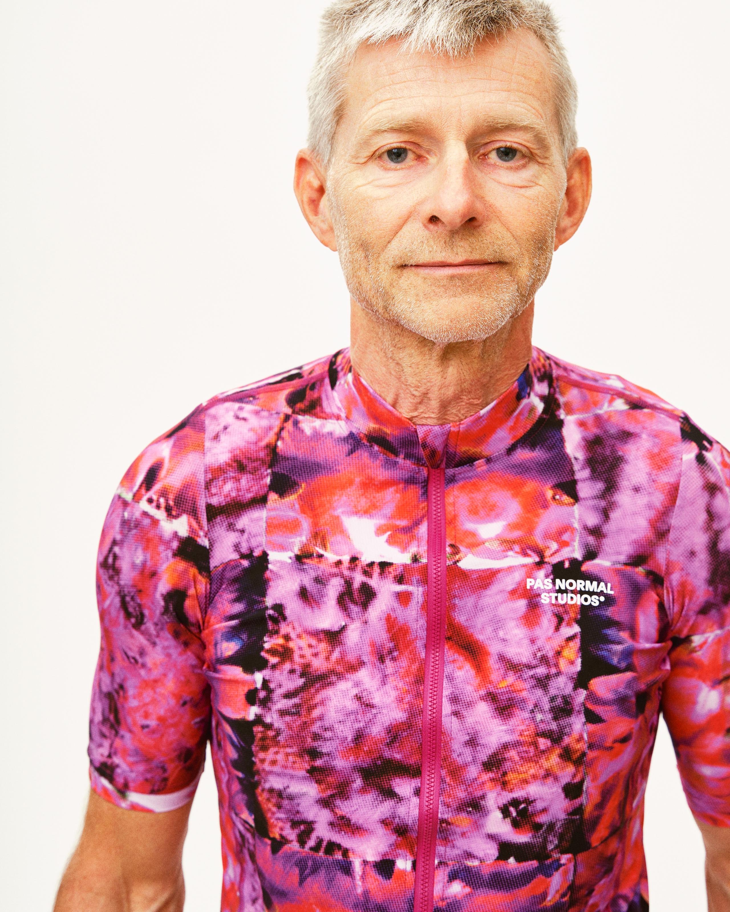 Pink Essential cycling jersey on model with kaleidoscope abstract print