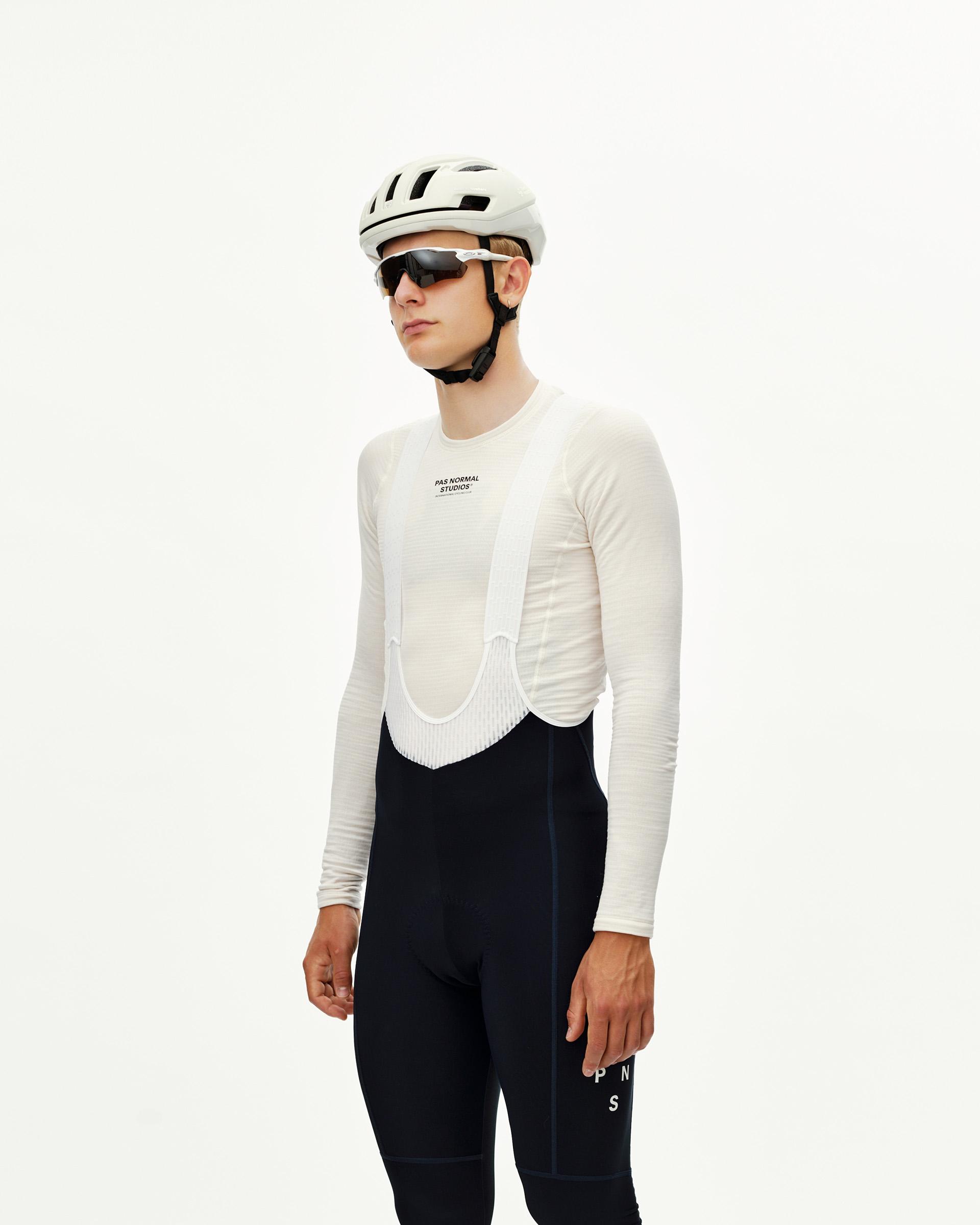 Navy Mechanism Thermal Long cycling bibs on model, front three-quarter view with white bib straps