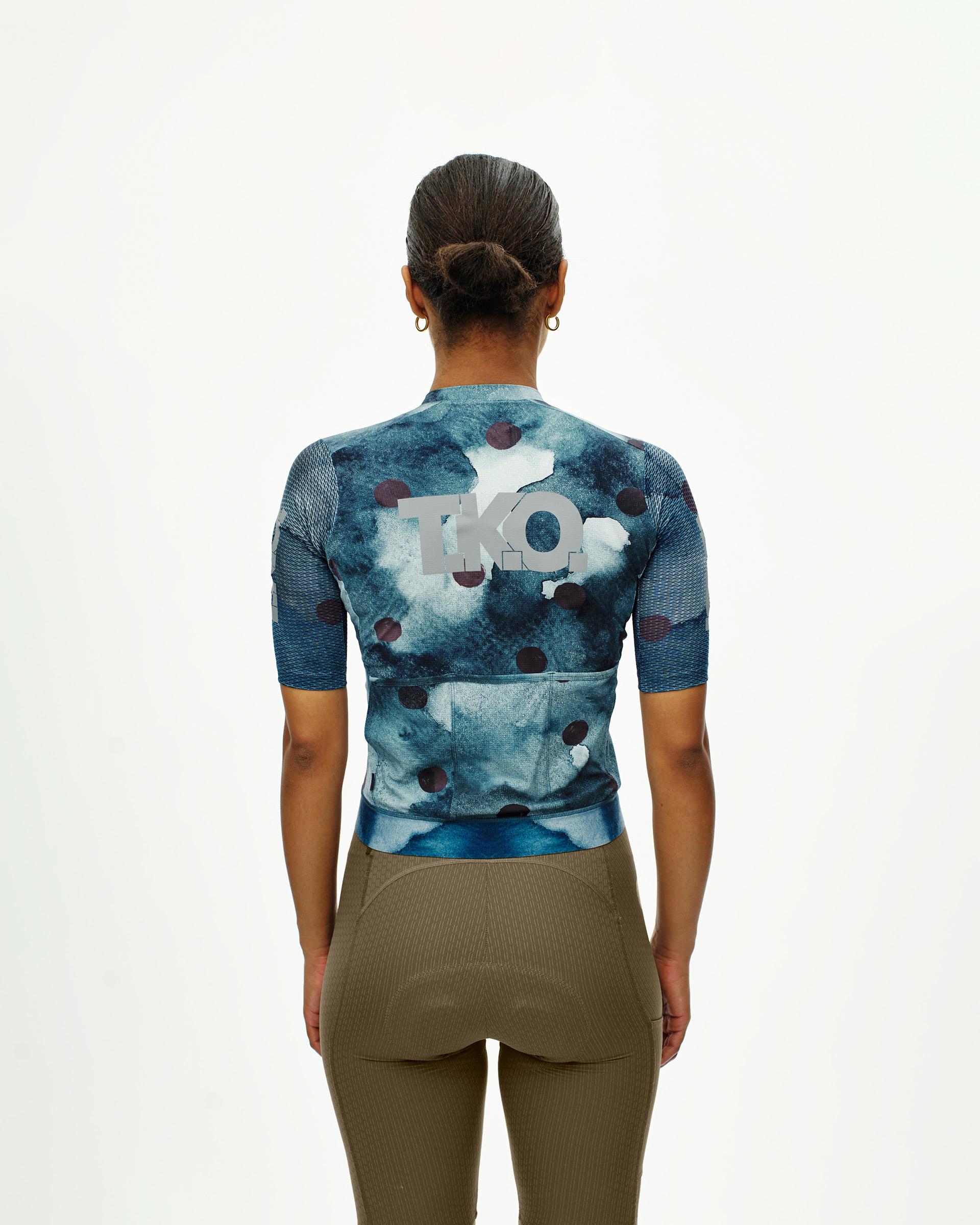 Blue T.K.O. Essential Light cycling jersey, rear view on model with abstract print and white logo