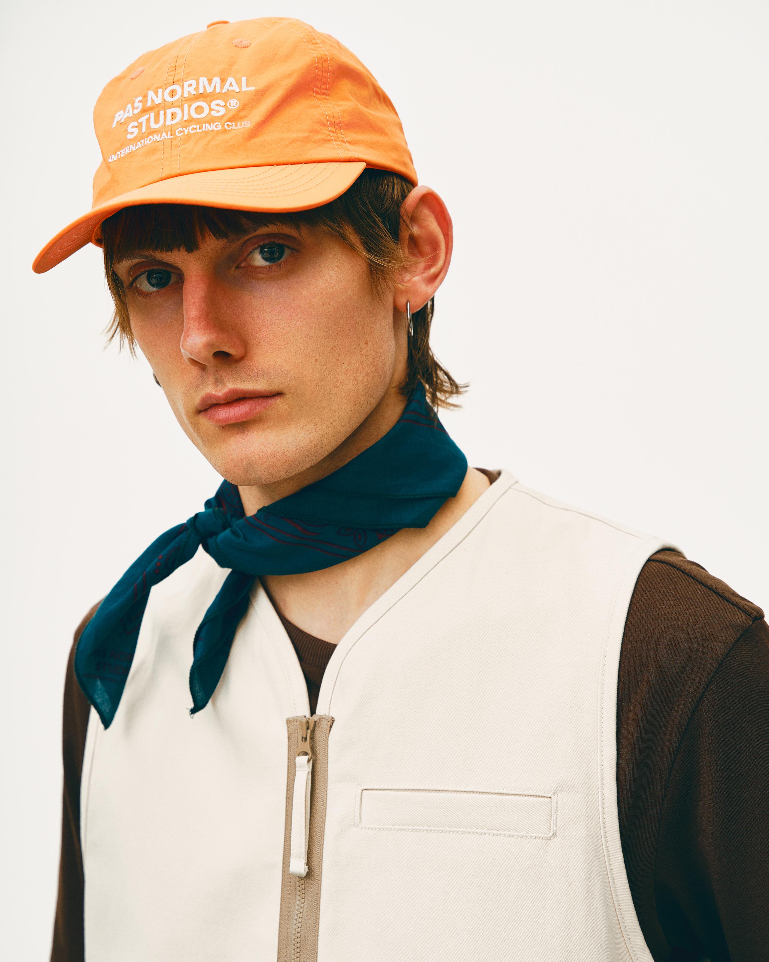 Orange Off-Race cap on model with white logo text