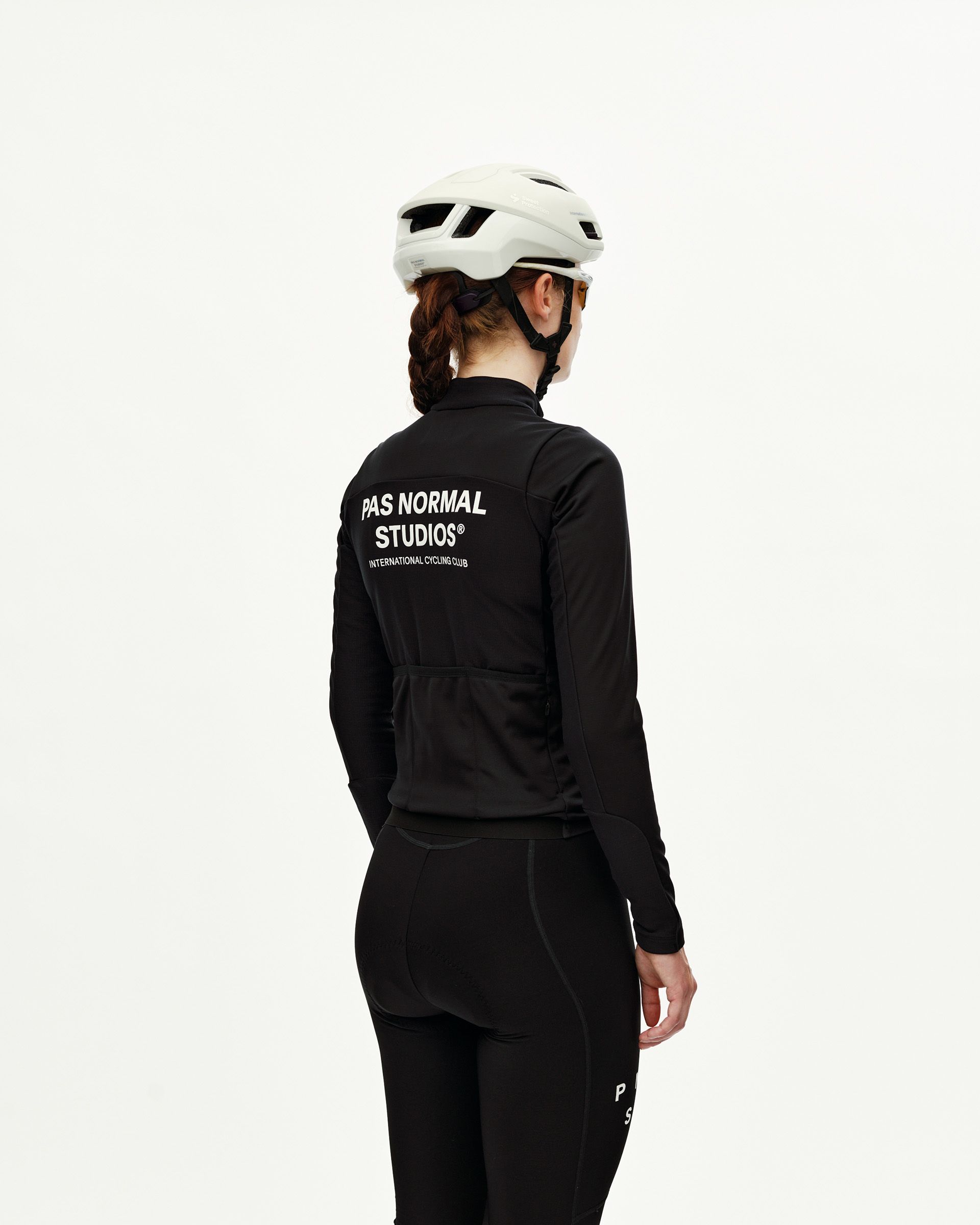 Black Mechanism Thermal Long Sleeve cycling jersey on model, rear view with white back print