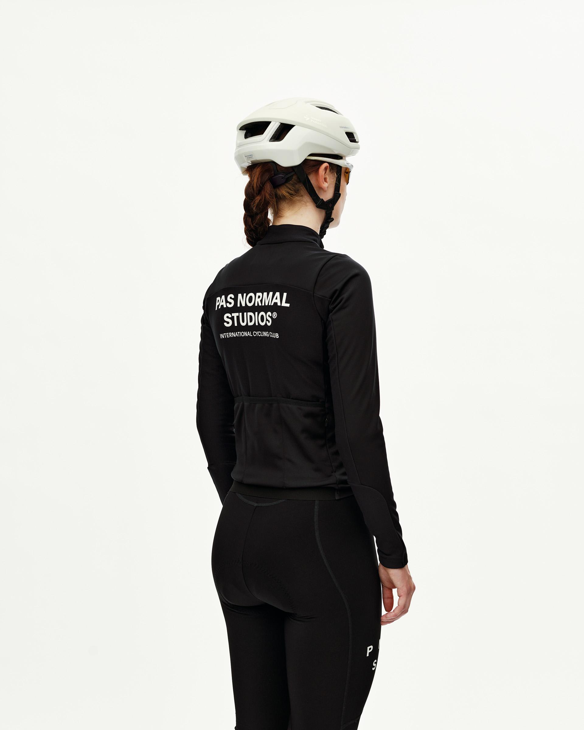 Black Mechanism Thermal Long Sleeve cycling jersey on model, rear view with white back print