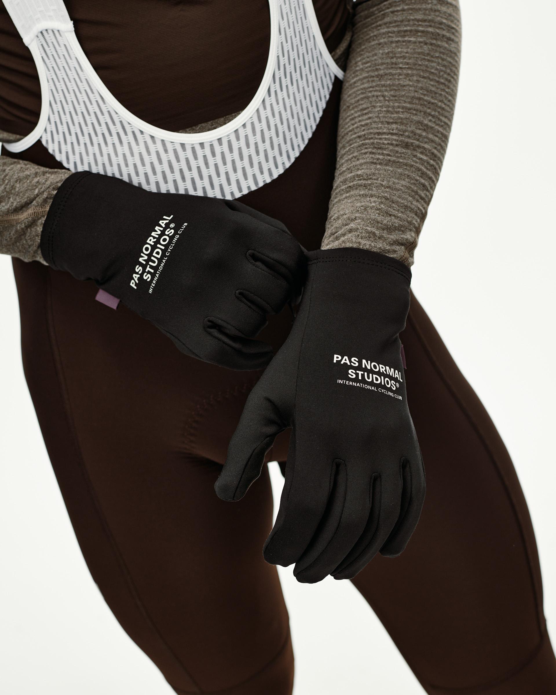 Black Logo Light cycling gloves on model, front view with white chest print on both hands
