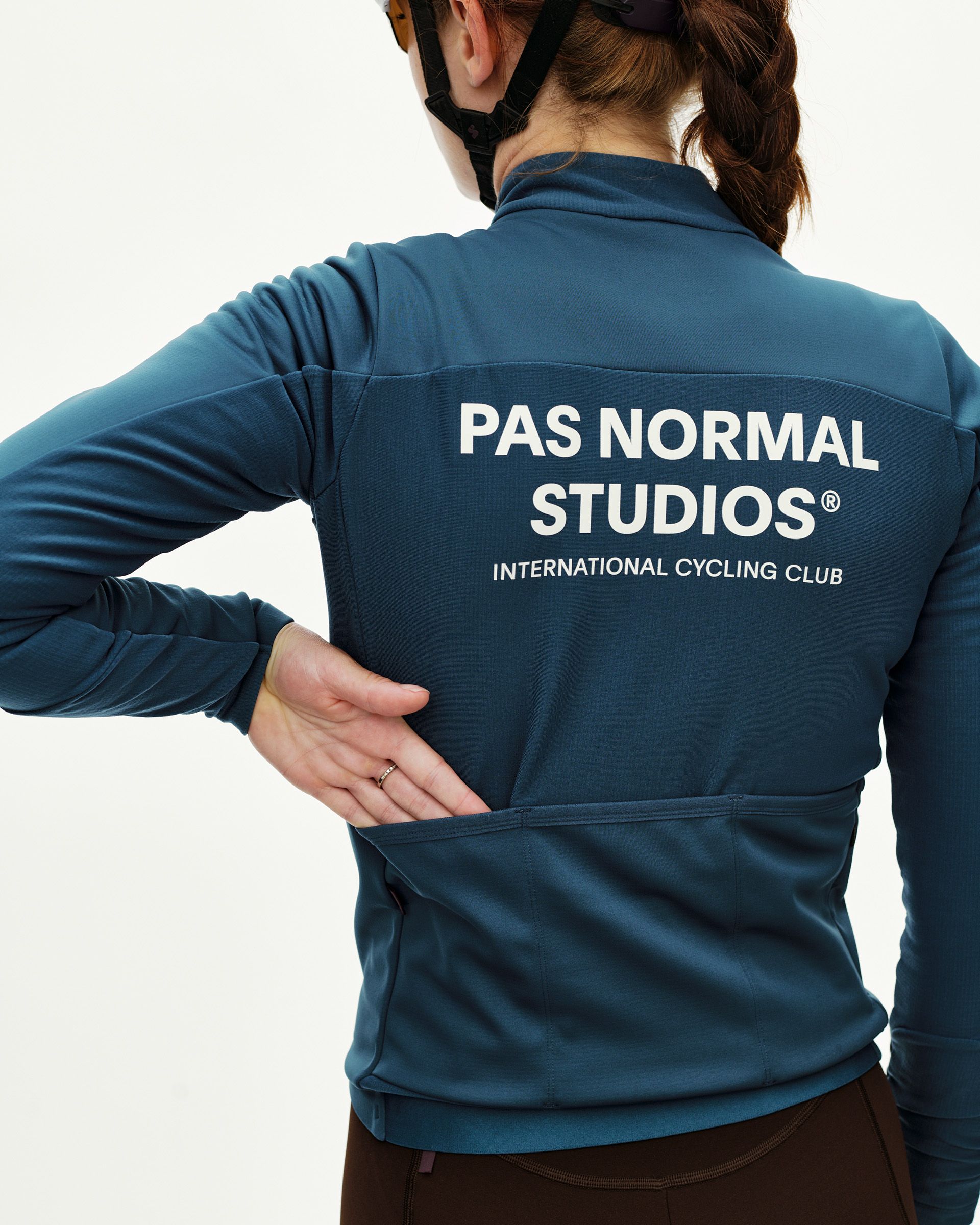 Linen blue Mechanism Thermal Long Sleeve 2.0 women's cycling jersey, rear view on model with white back logo print