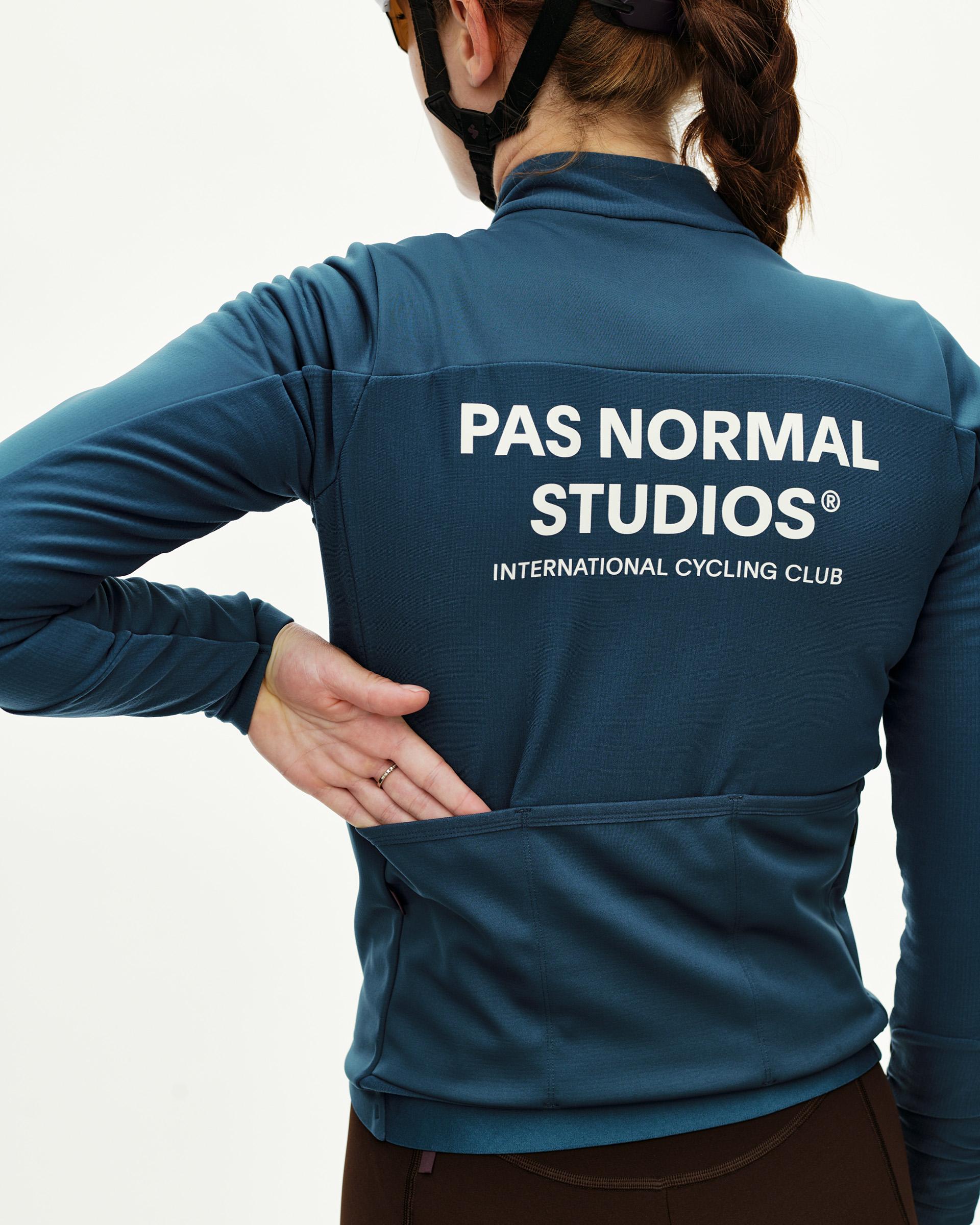 Linen blue Mechanism Thermal Long Sleeve 2.0 women's cycling jersey, rear view on model with white back logo print