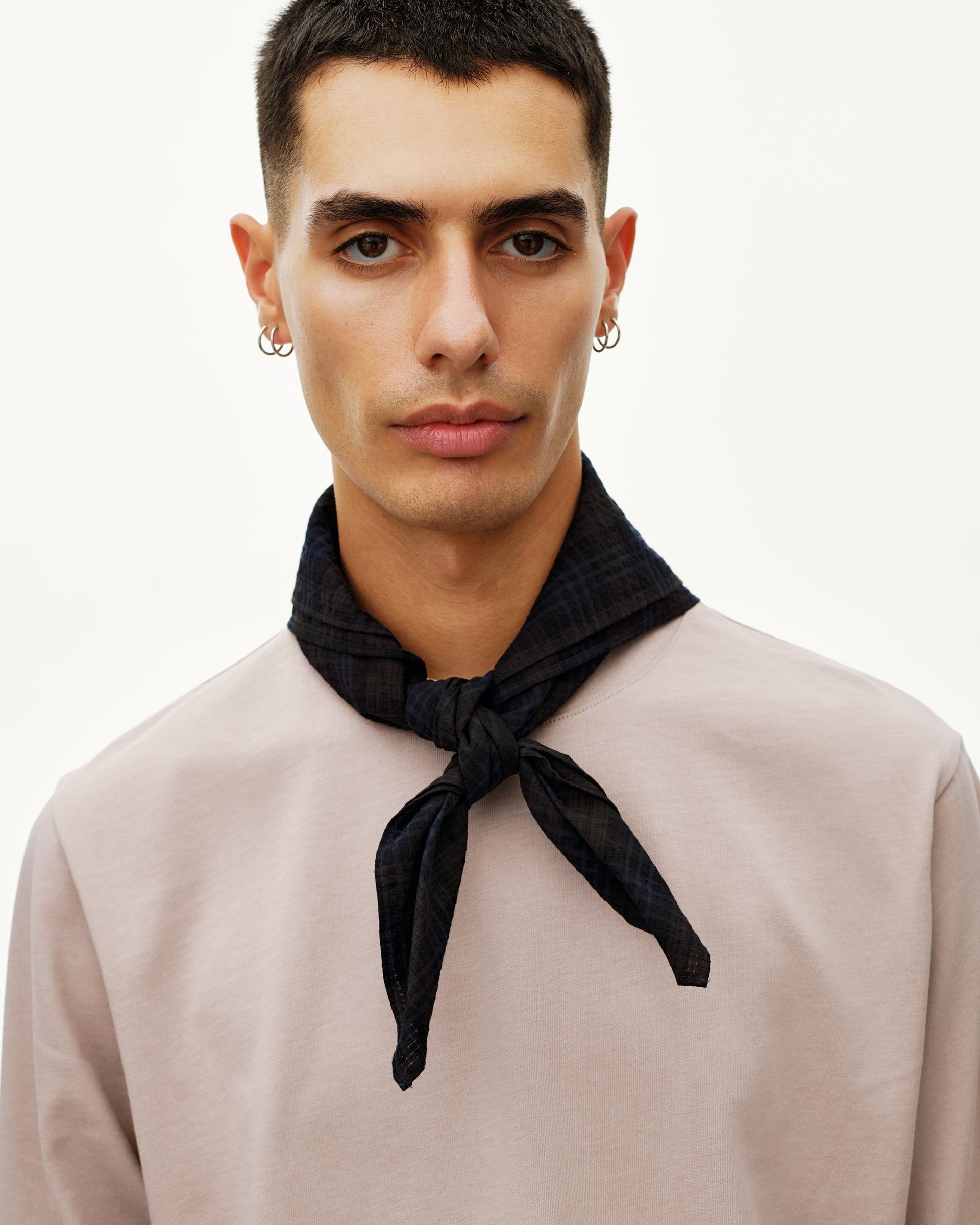 Dark Navy Off-Race Seersucker bandana on model, tied at neck over a light pink sweatshirt