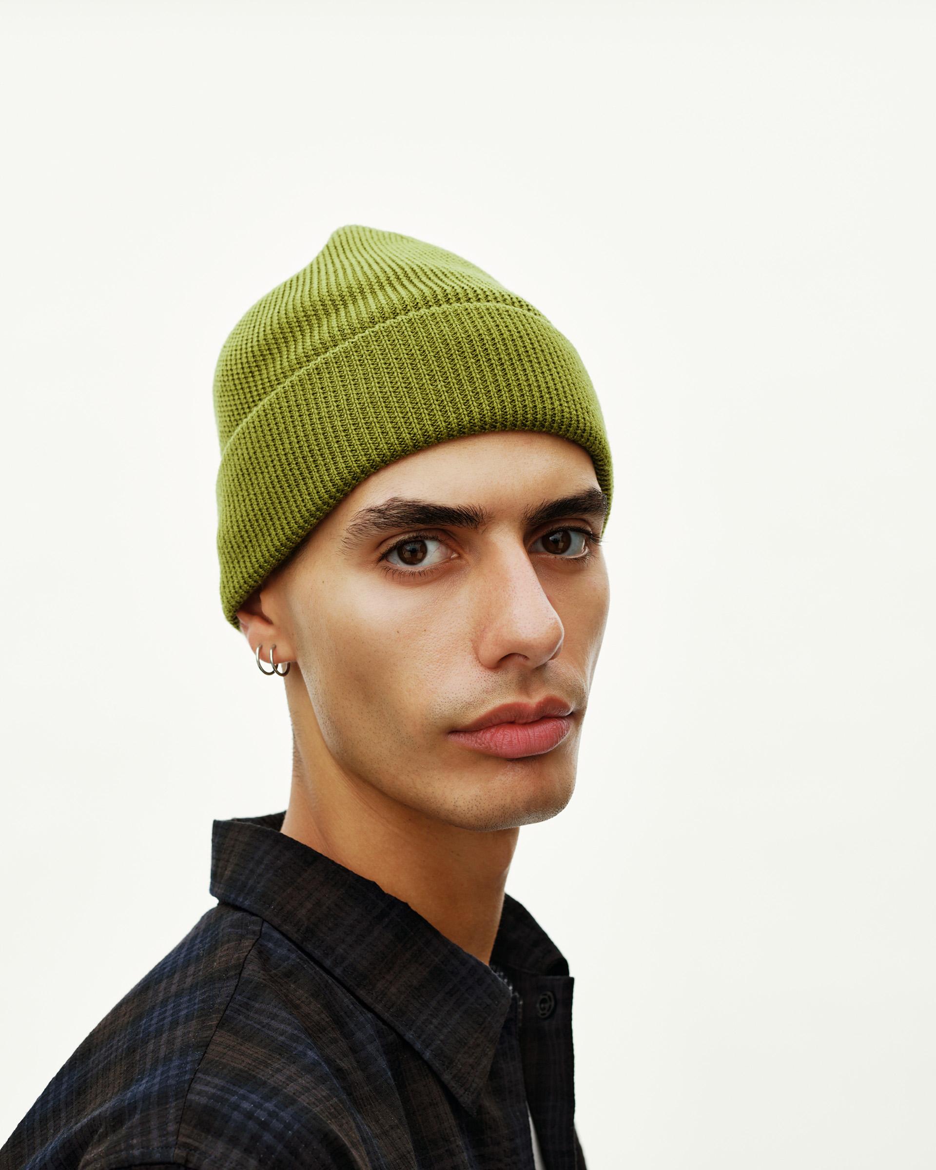 Dark Lime Off-Race Wool Knit beanie on model, three-quarter front view with ribbed cuff