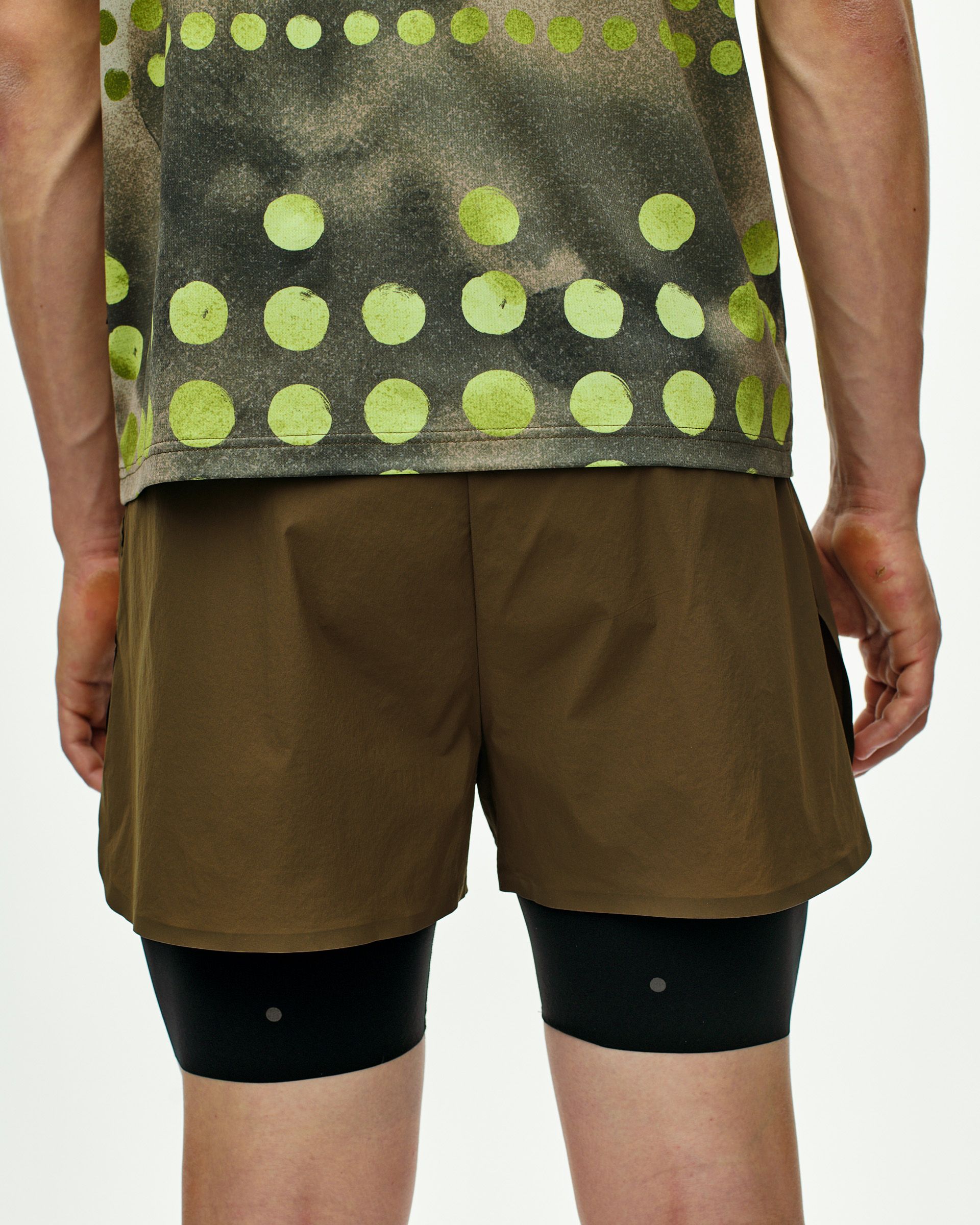 Dark Stone T.K.O. Balance 2-in-1 shorts on model, rear view with outer shorts over compression shorts