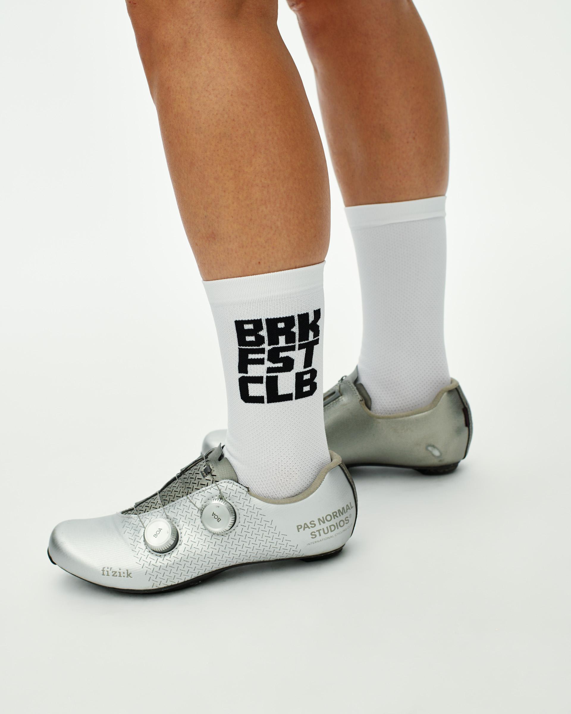 White Breakfast Club cycling socks on model with black text print
