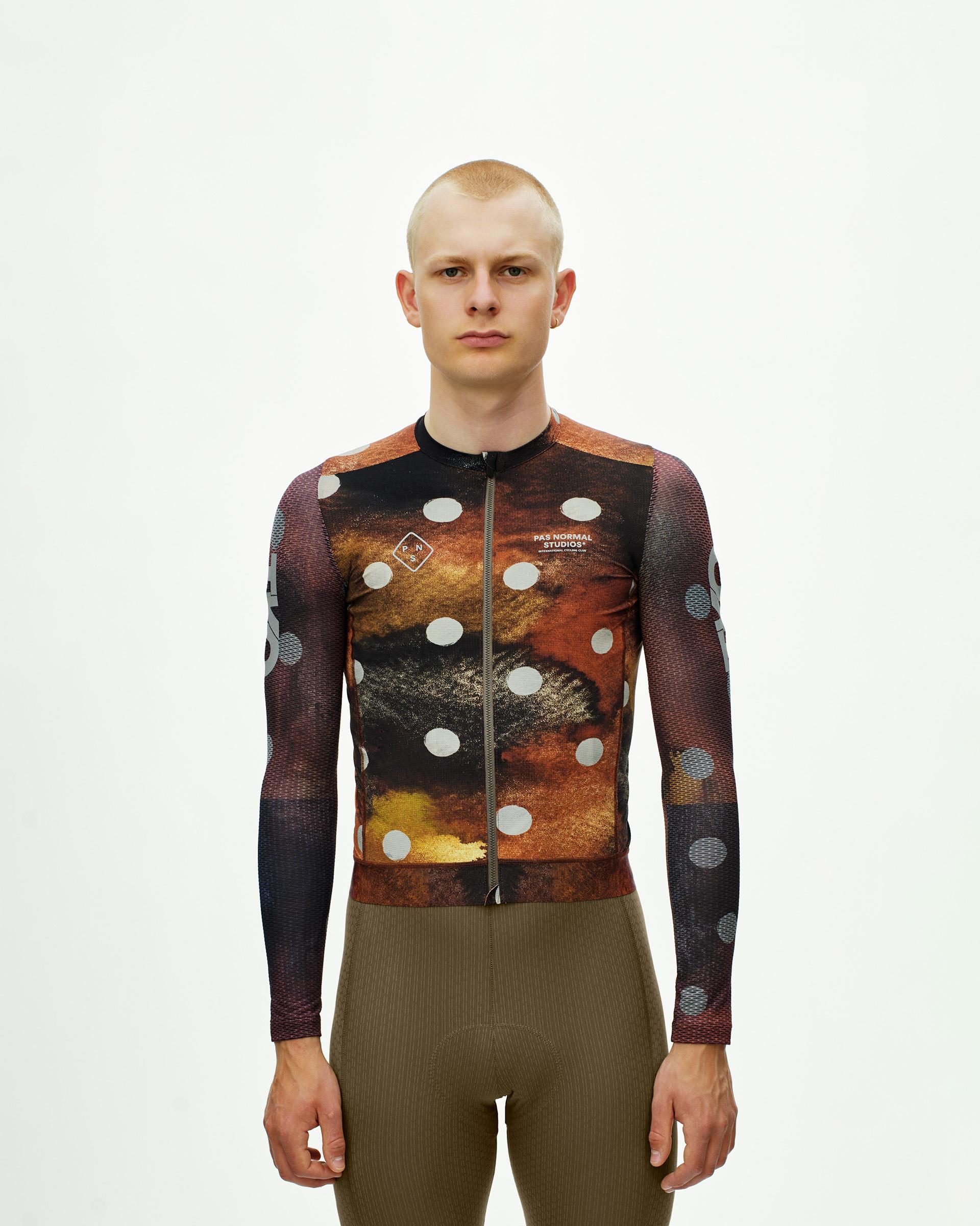 Brown T.K.O. Essential Light long sleeve cycling jersey on model with abstract earth tone print and white dots
