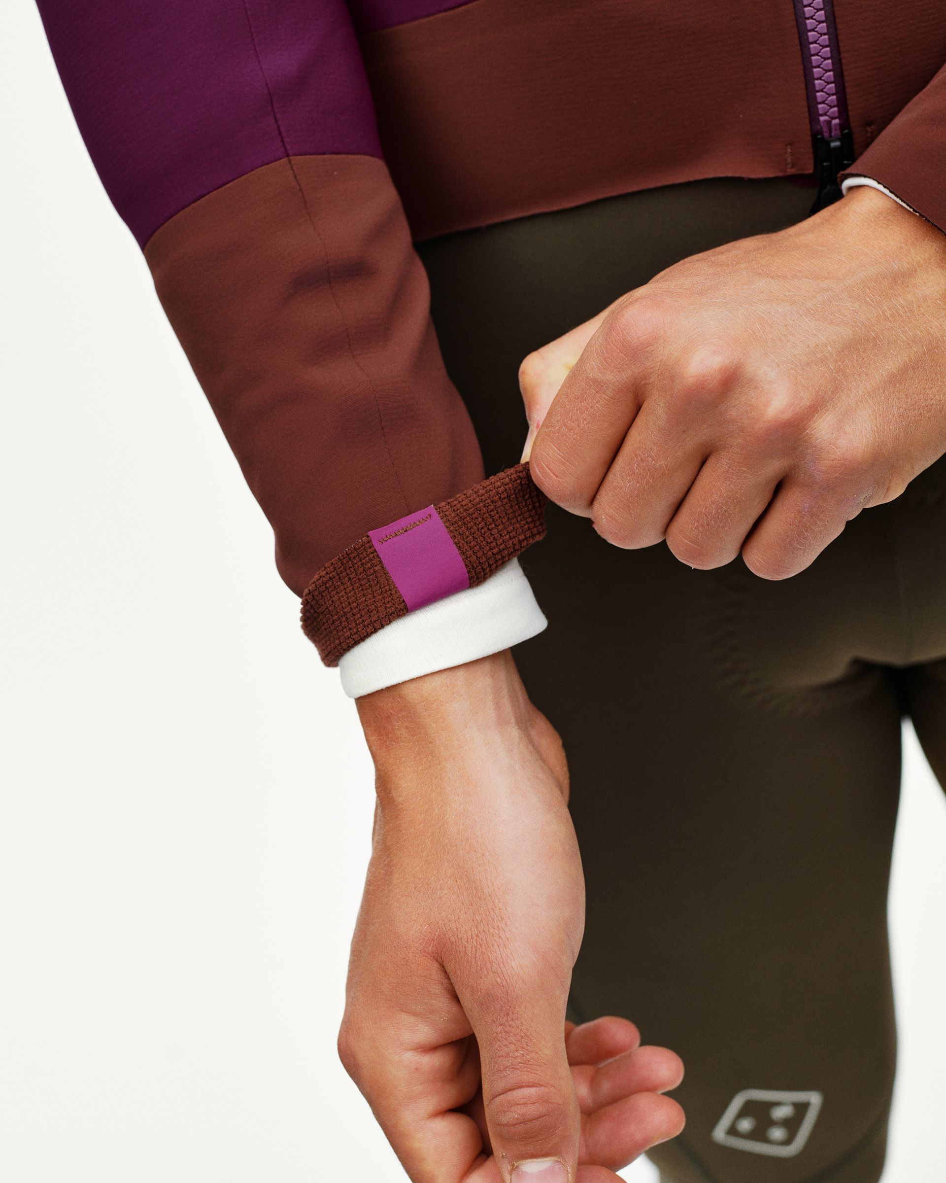 Dark Purple PAS Mechanism cycling jacket, wrist cuff detail on model with adjustable strap closure