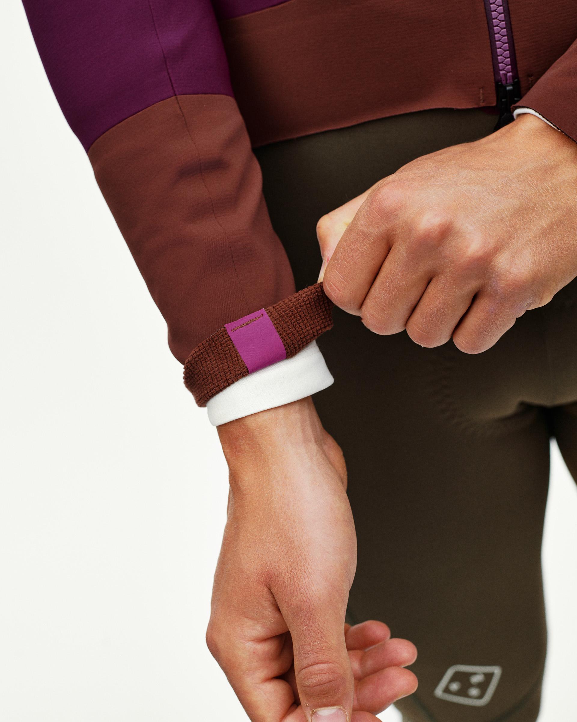Dark Purple PAS Mechanism cycling jacket, wrist cuff detail on model with adjustable strap closure