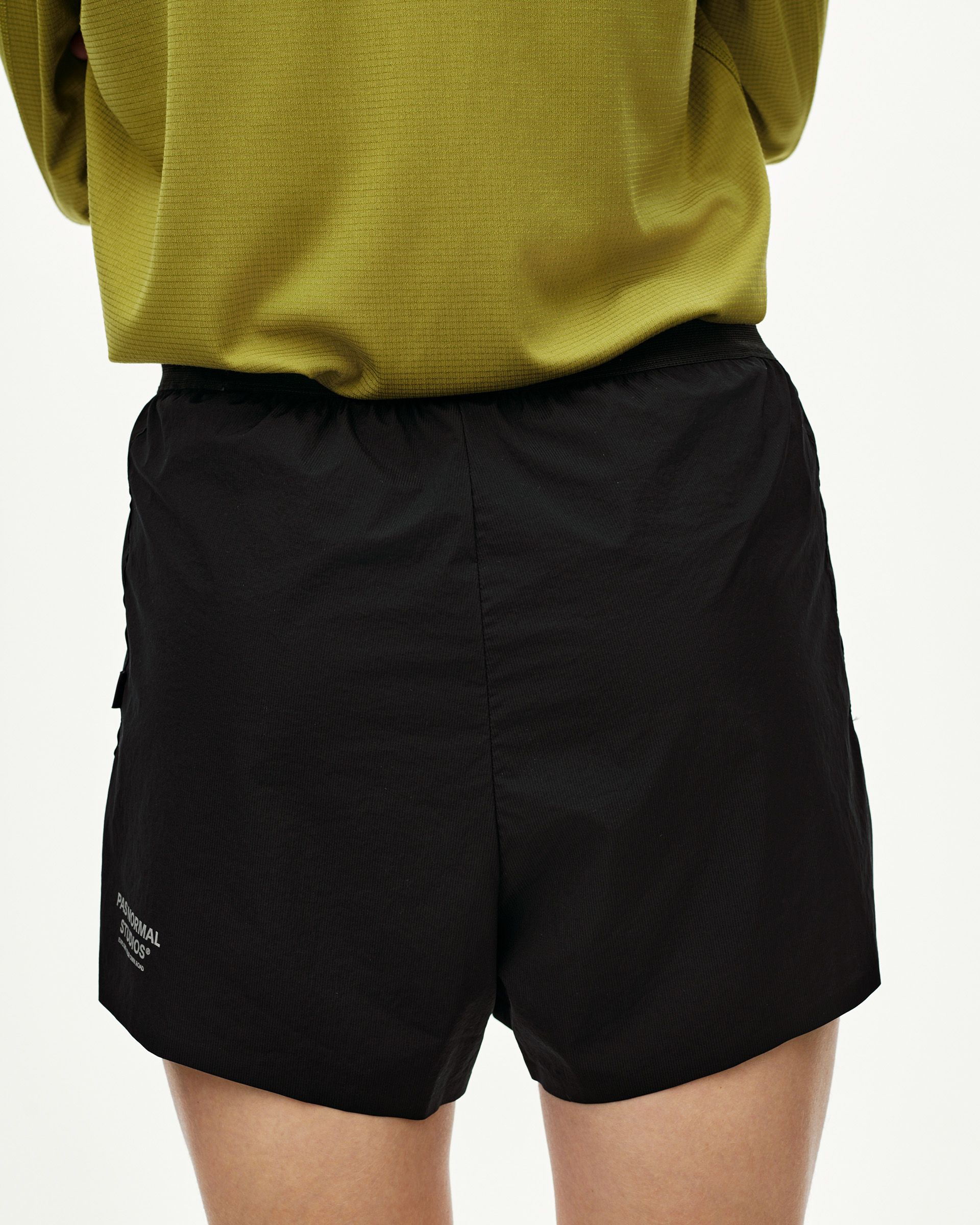 Black Balance 2-in-1 shorts on model, front view with elastic waistband and side cargo pocket