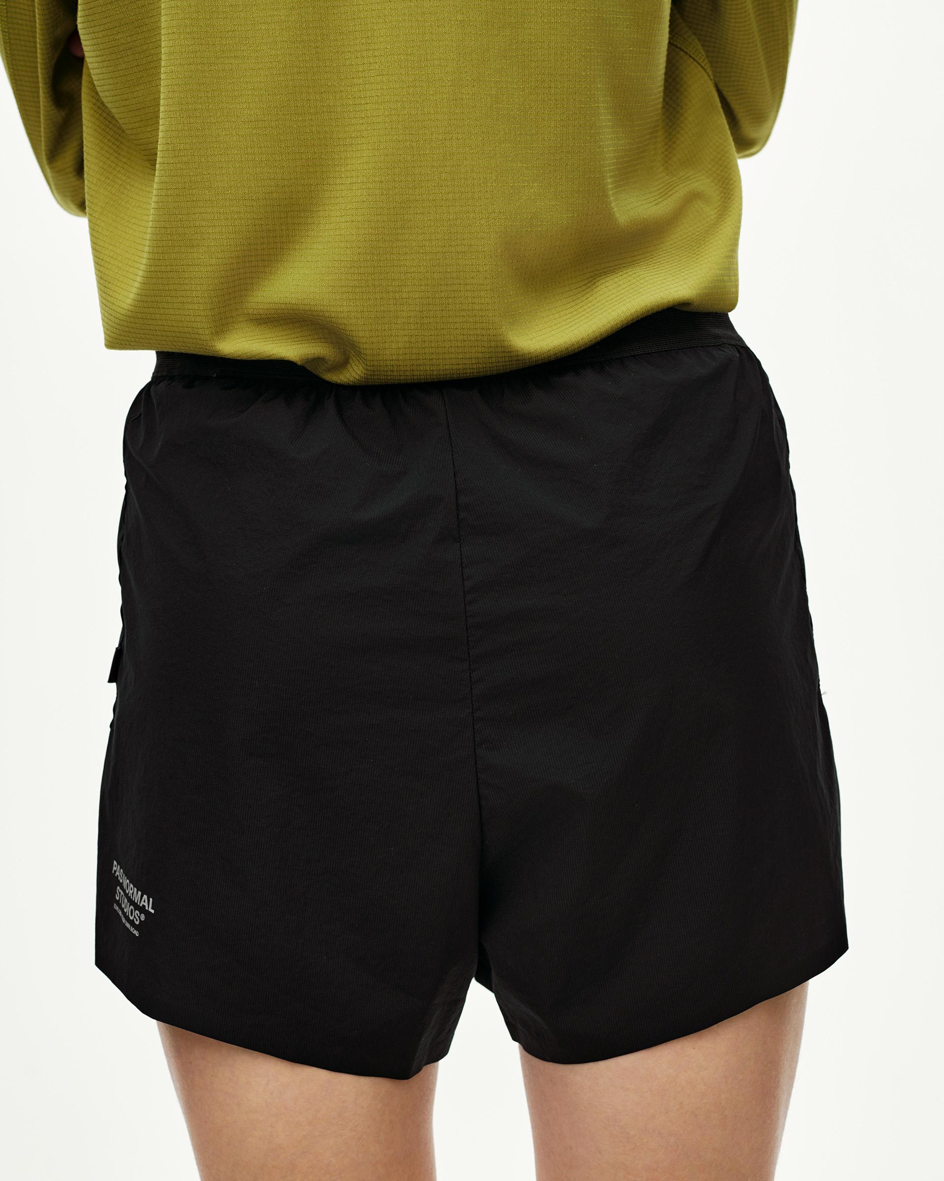 Black Balance 2-in-1 shorts on model, front view with elastic waistband and side cargo pocket