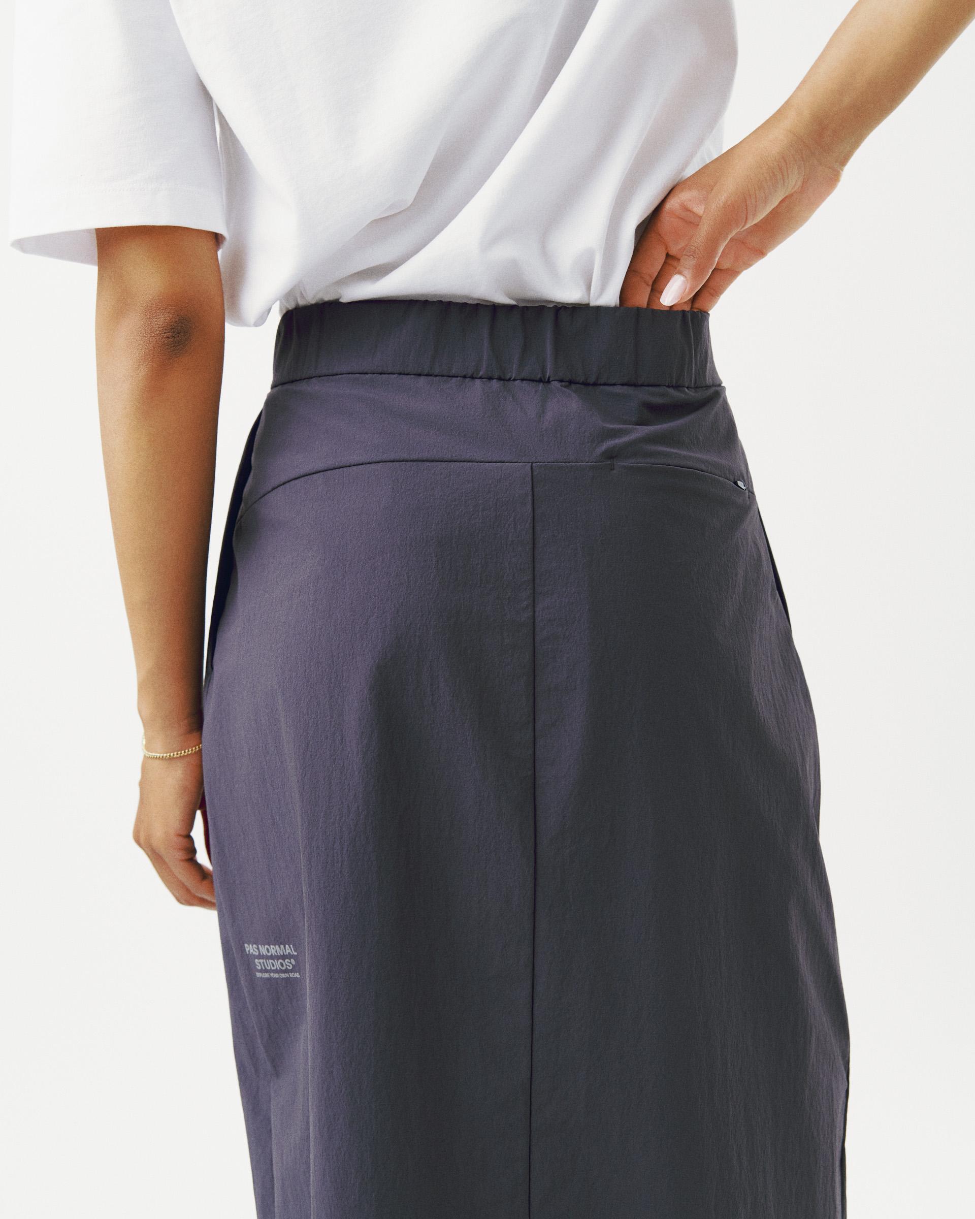 Steel Off-Race Tech Skirt on model, rear view with elastic waistband and white logo print